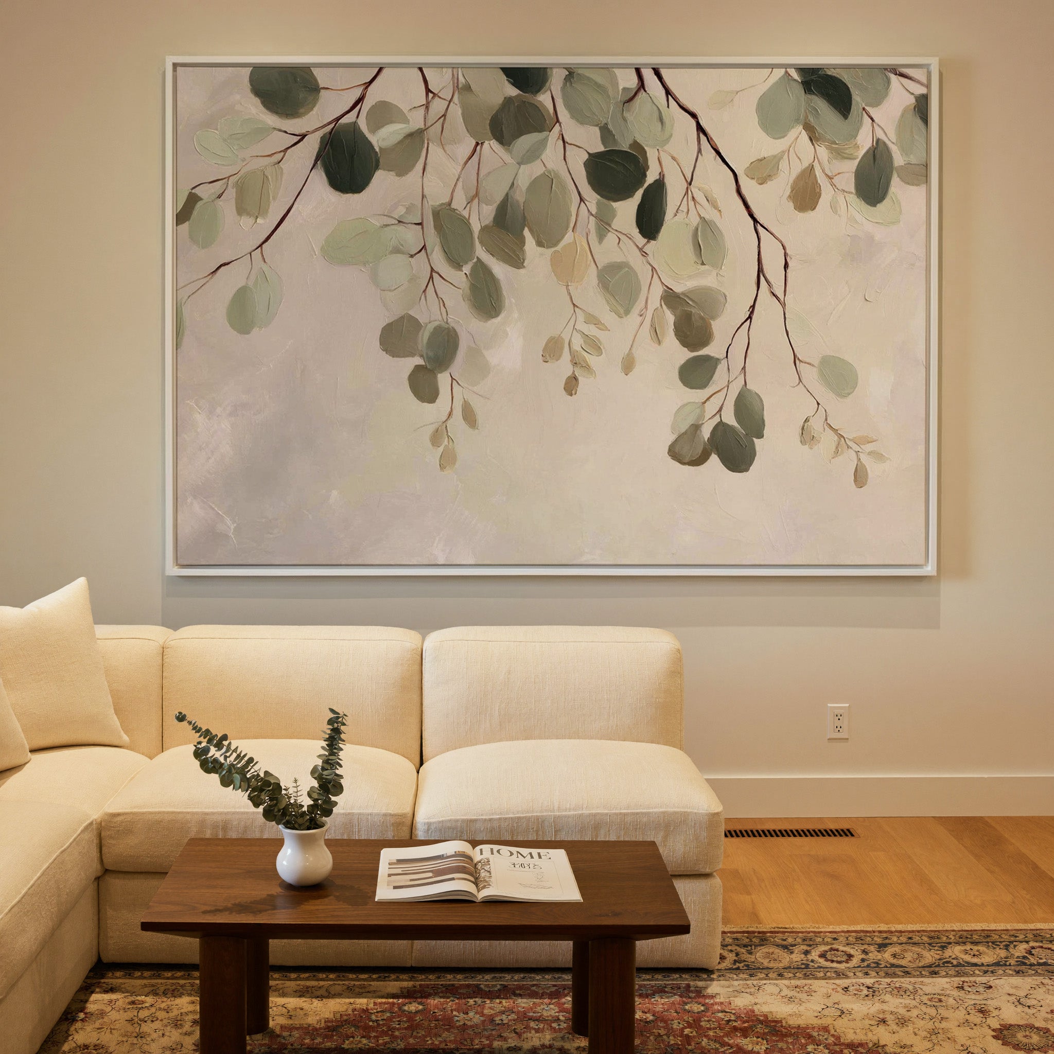 airy eucalyptus leaves on pale ground canvas wall art in a white frame in a styled room setting