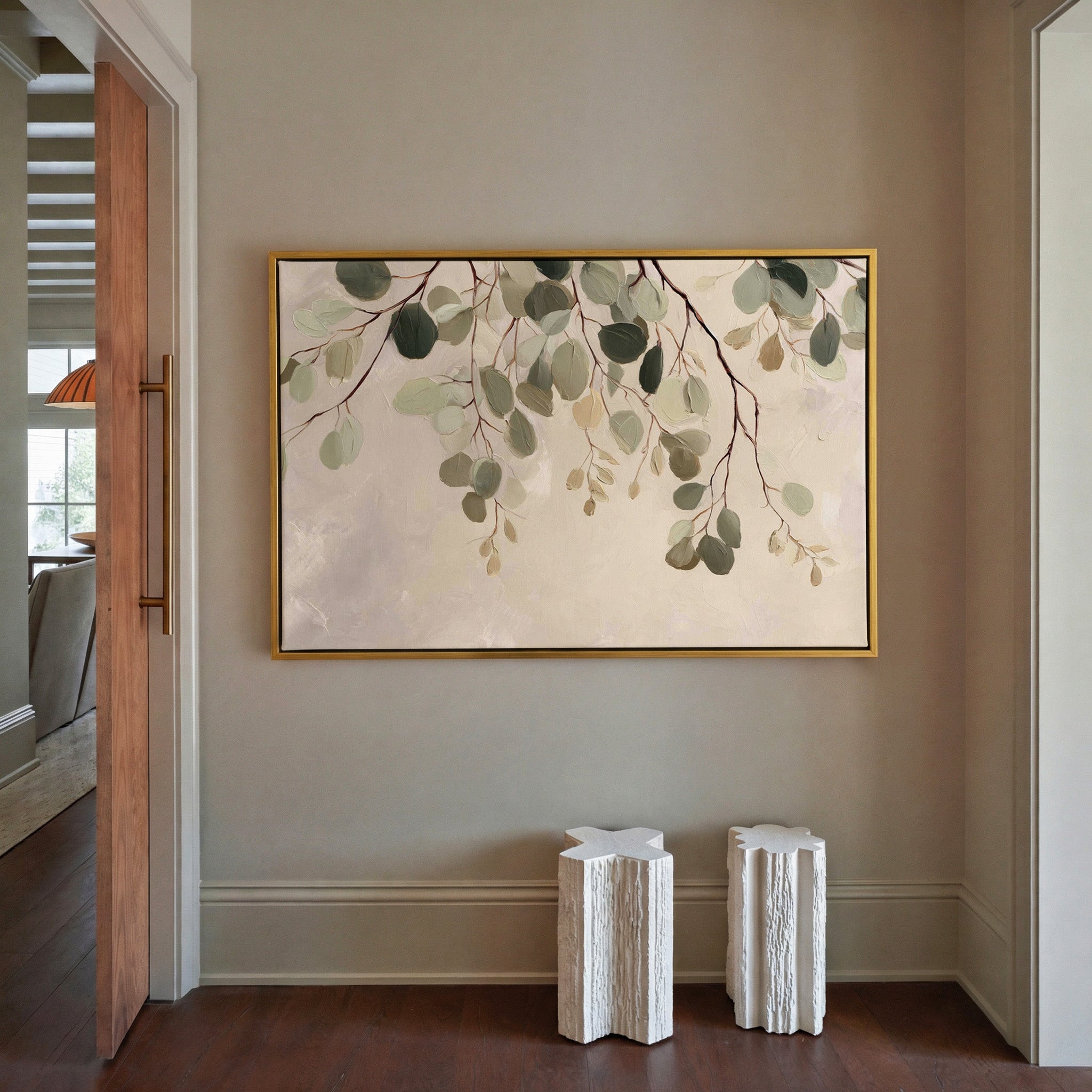 airy eucalyptus leaves on pale ground canvas wall art in a gold frame in a styled room setting