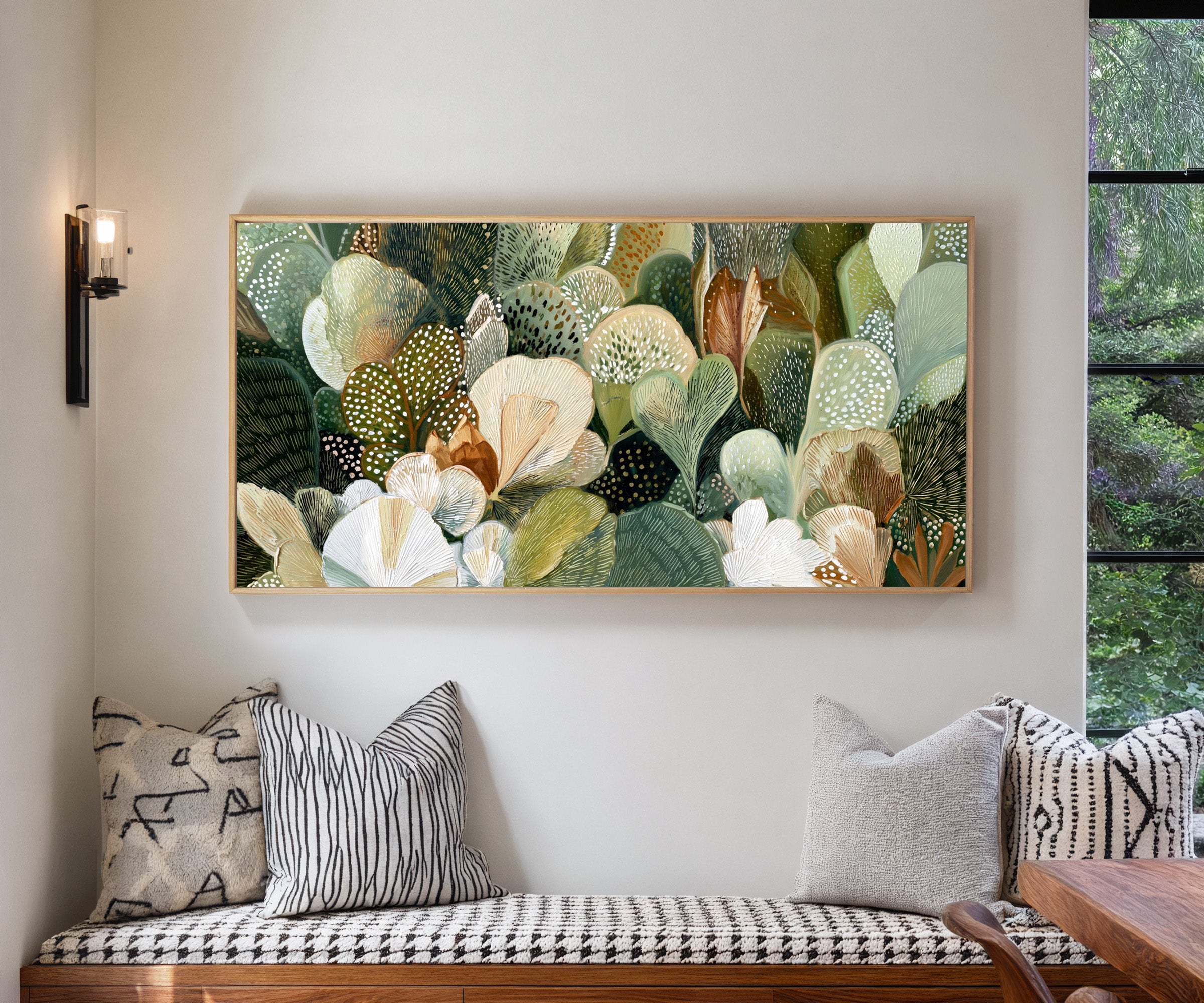 dense green and cream leaf forms canvas wall art in a natural wood frame in a living room