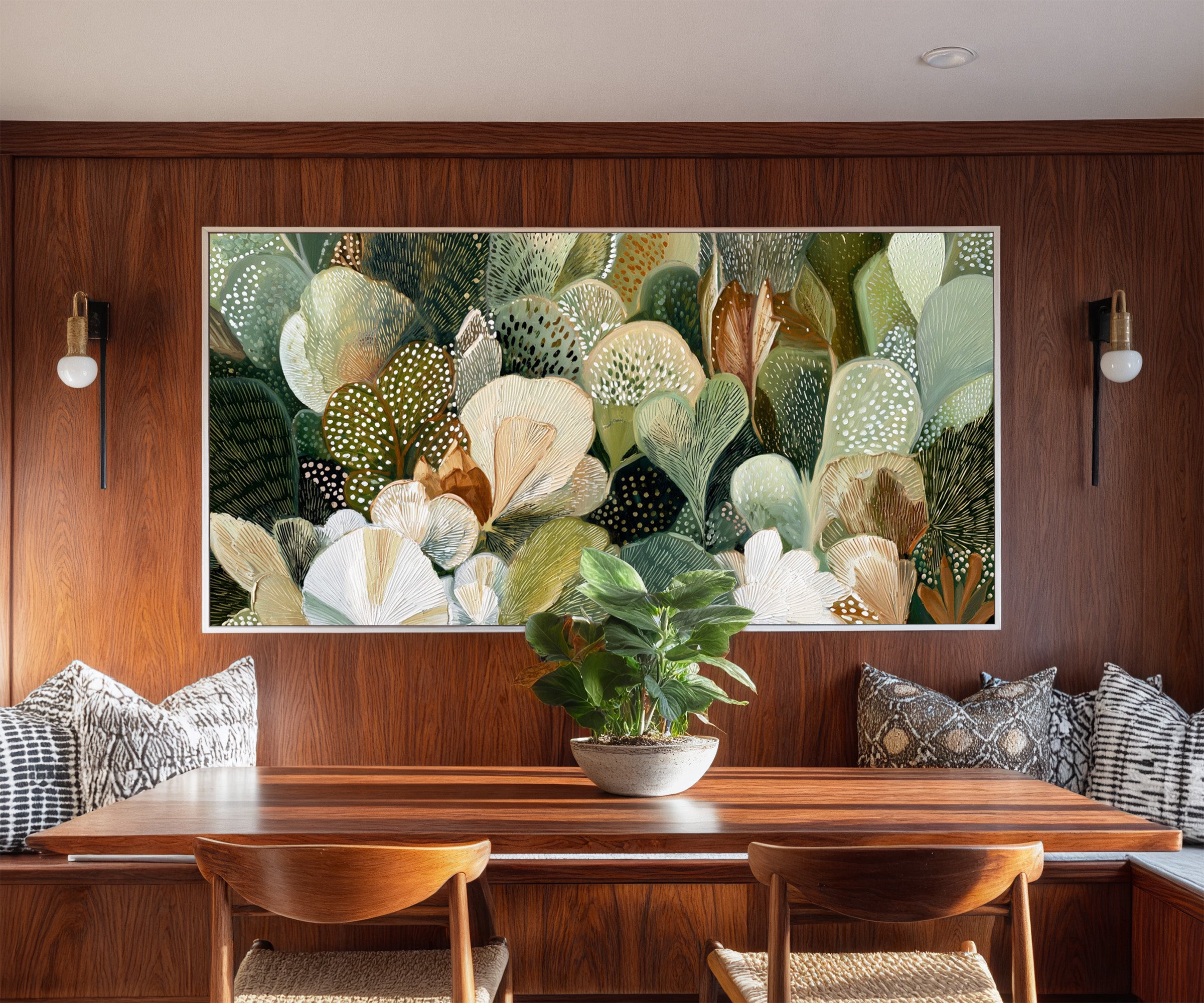 dense green and cream leaf forms canvas wall art in a white frame in a styled room setting