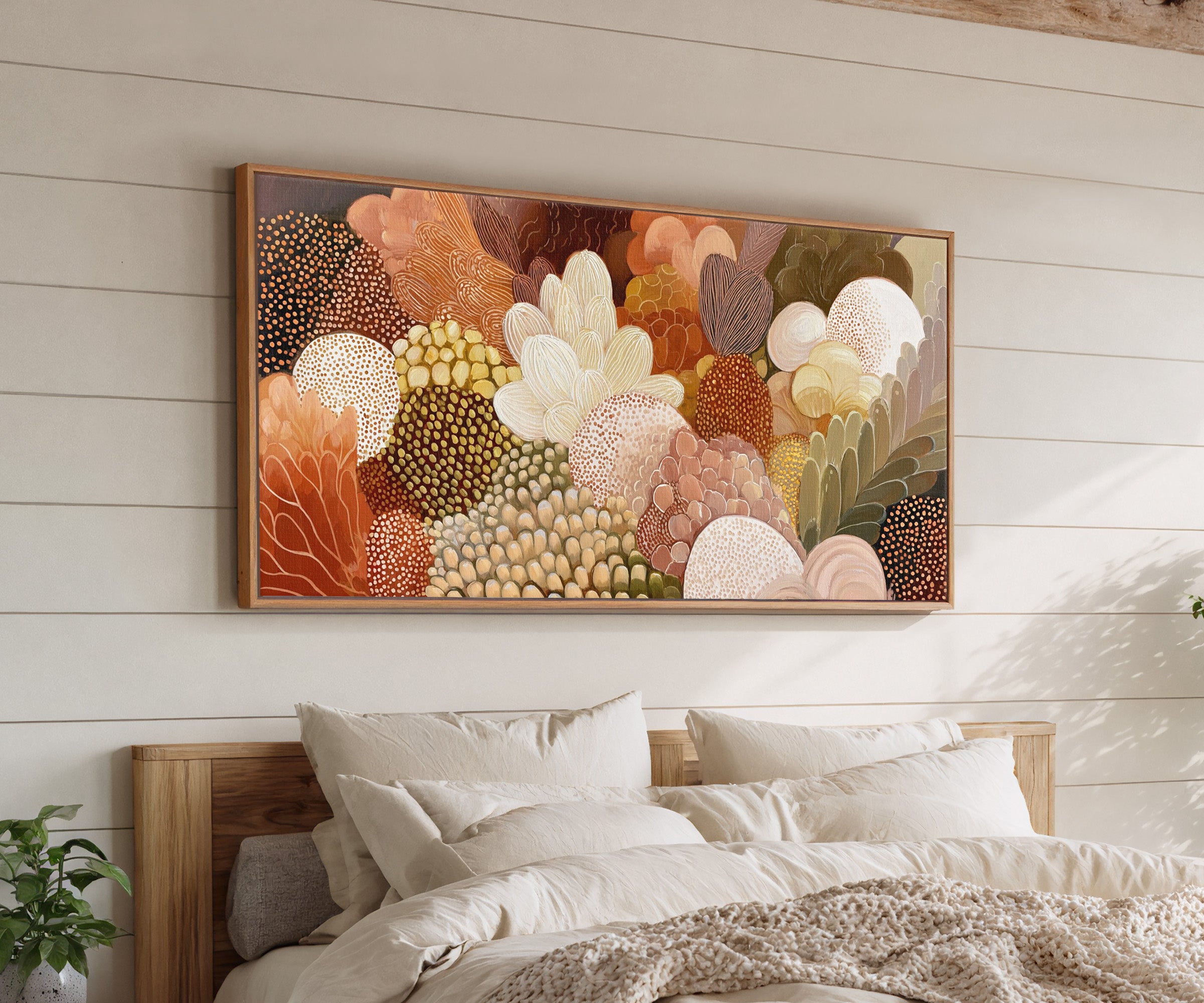 dense layered botanical forms in warm neutrals, canvas wall art in an oak frame above a bed