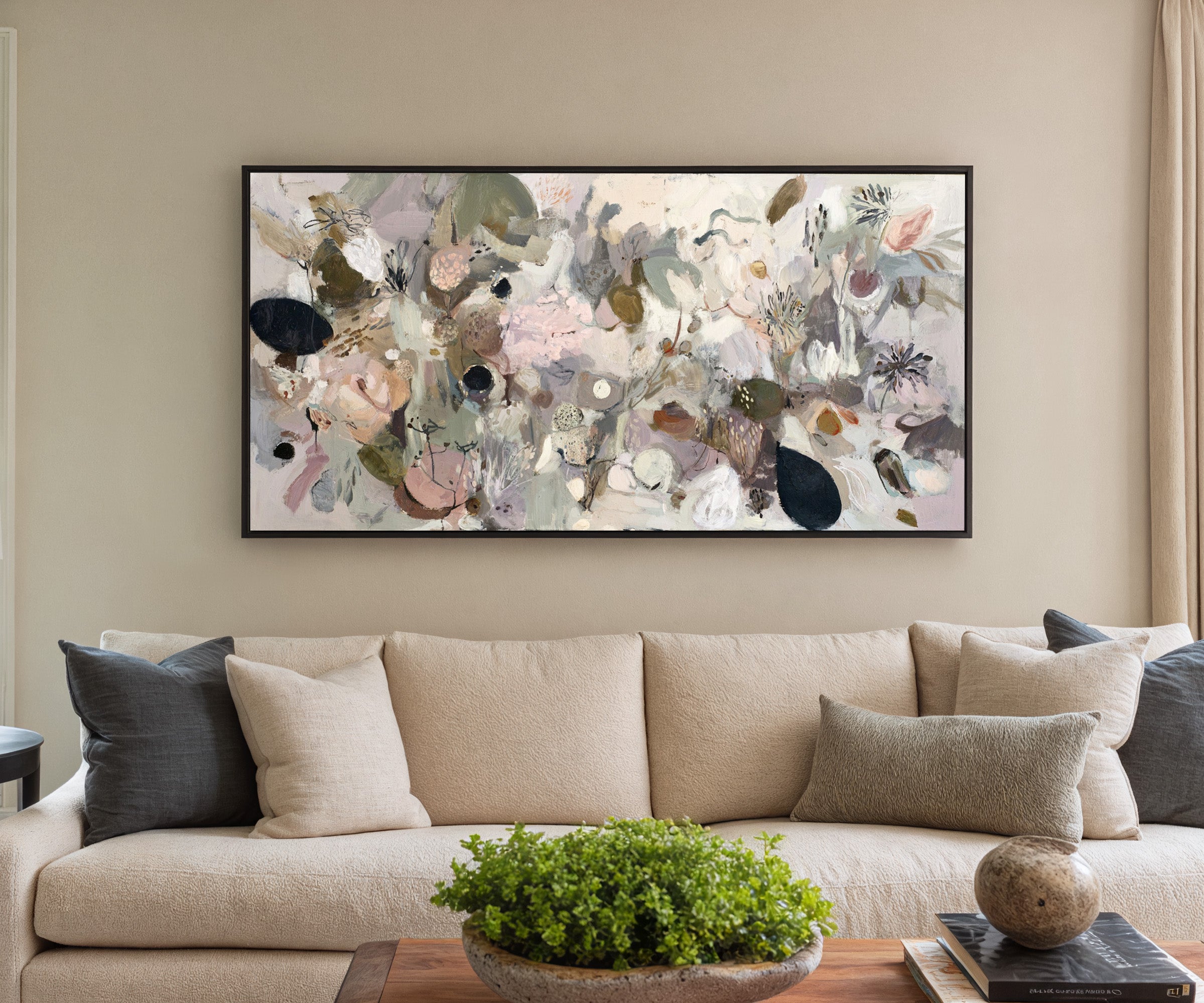 neutral abstract with moss green, taupe, beige, canvas wall art in a black frame in a styled room setting