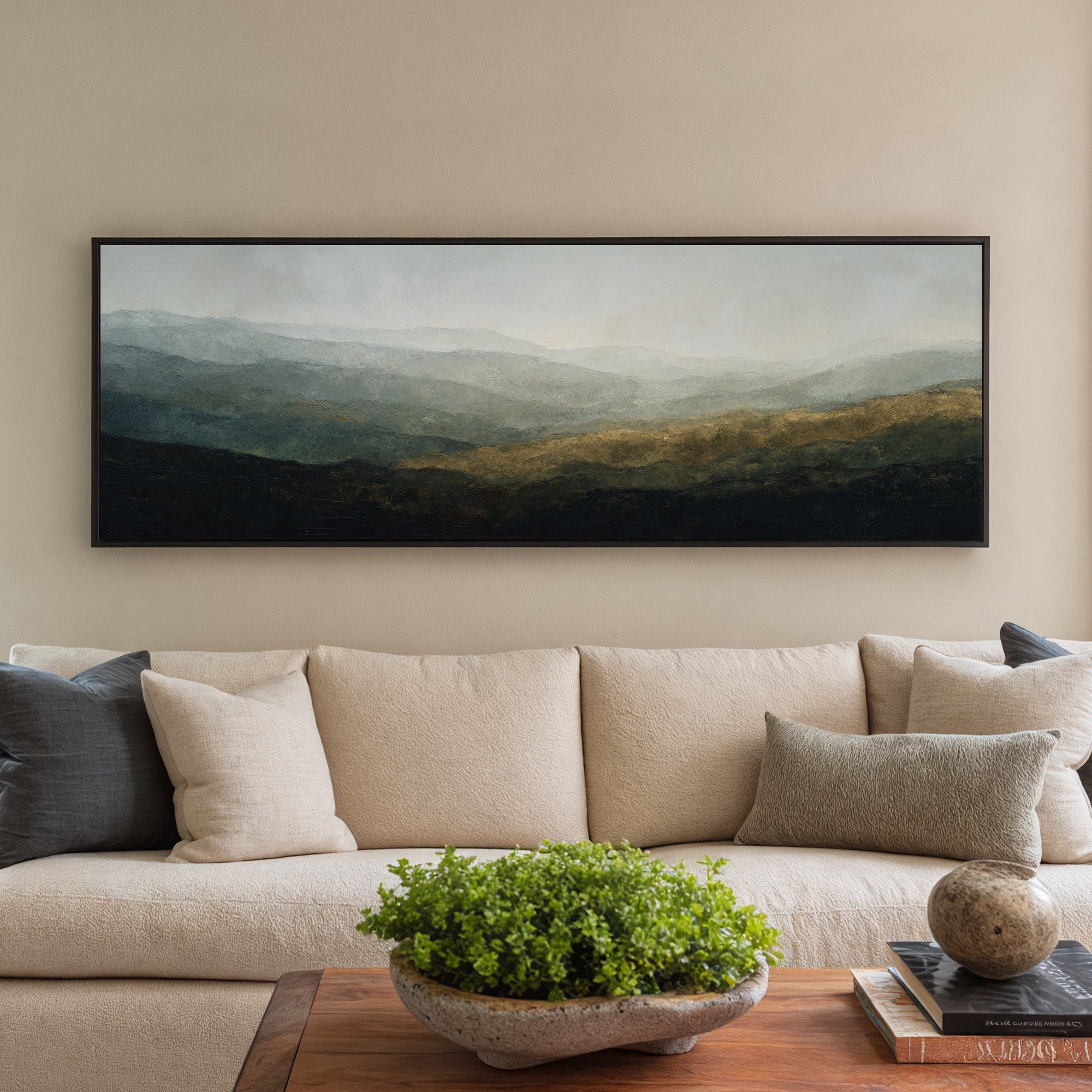 soft layered mountain landscape with diffused canvas wall art in a black frame in a styled room setting
