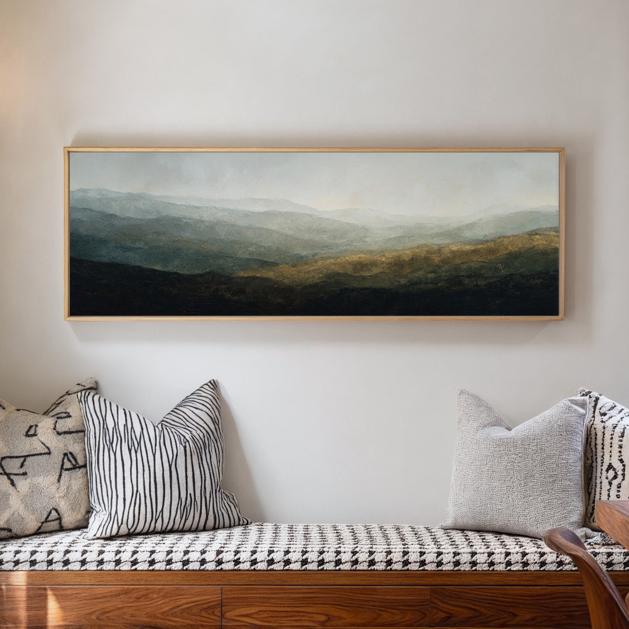 soft layered mountain landscape with diffused canvas wall art in a natural wood frame in a living room