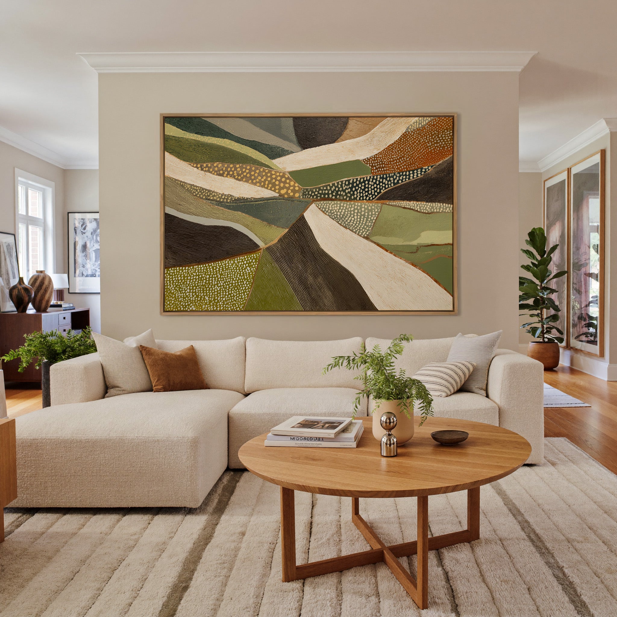 layered olive, cream, and brown abstract with canvas wall art in an oak frame in a living room