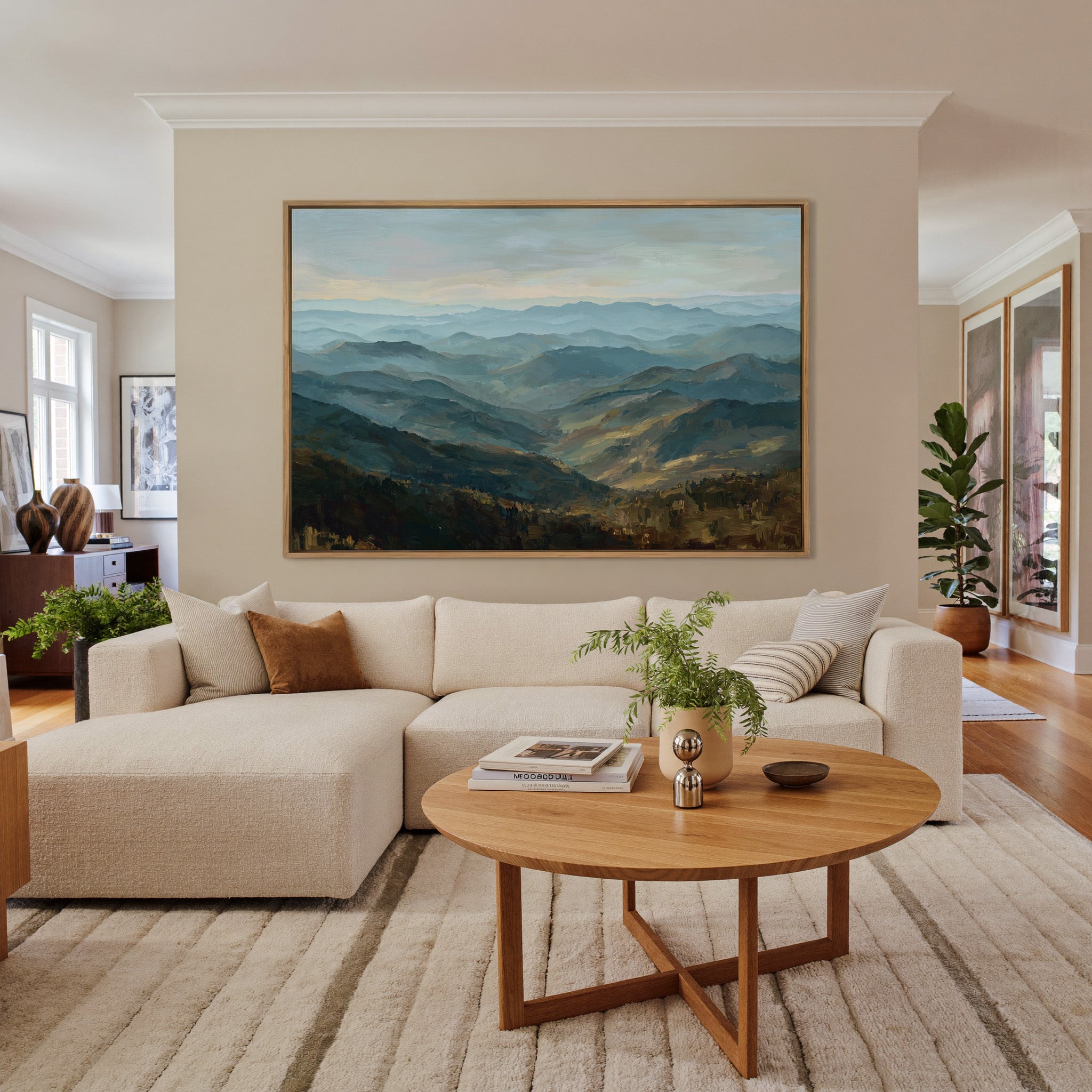 layered blue ridgelines with pale sky and warm canvas wall art in an oak frame in a living room
