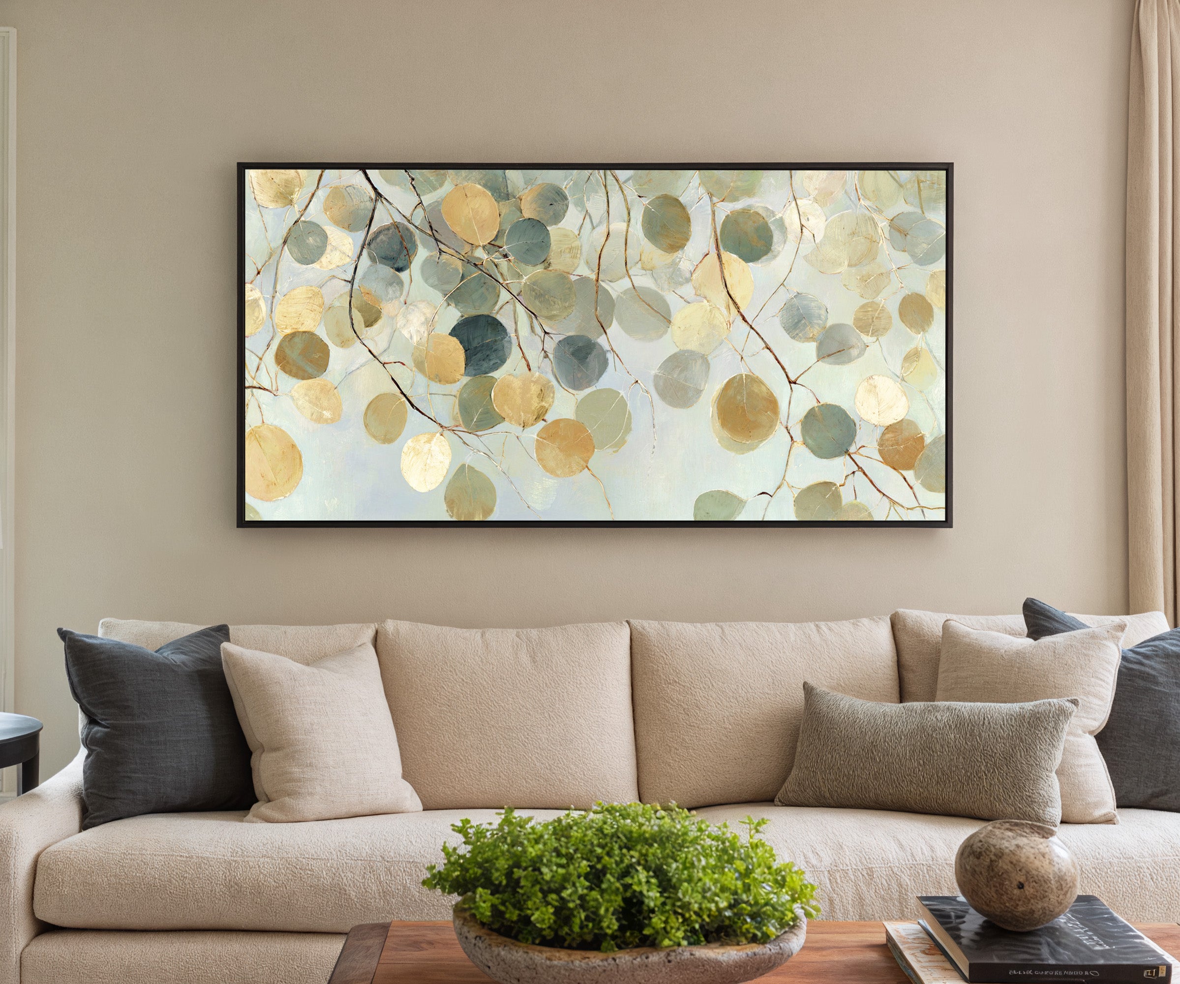 pale round leaves on branching stems canvas wall art in a black frame in a styled room setting