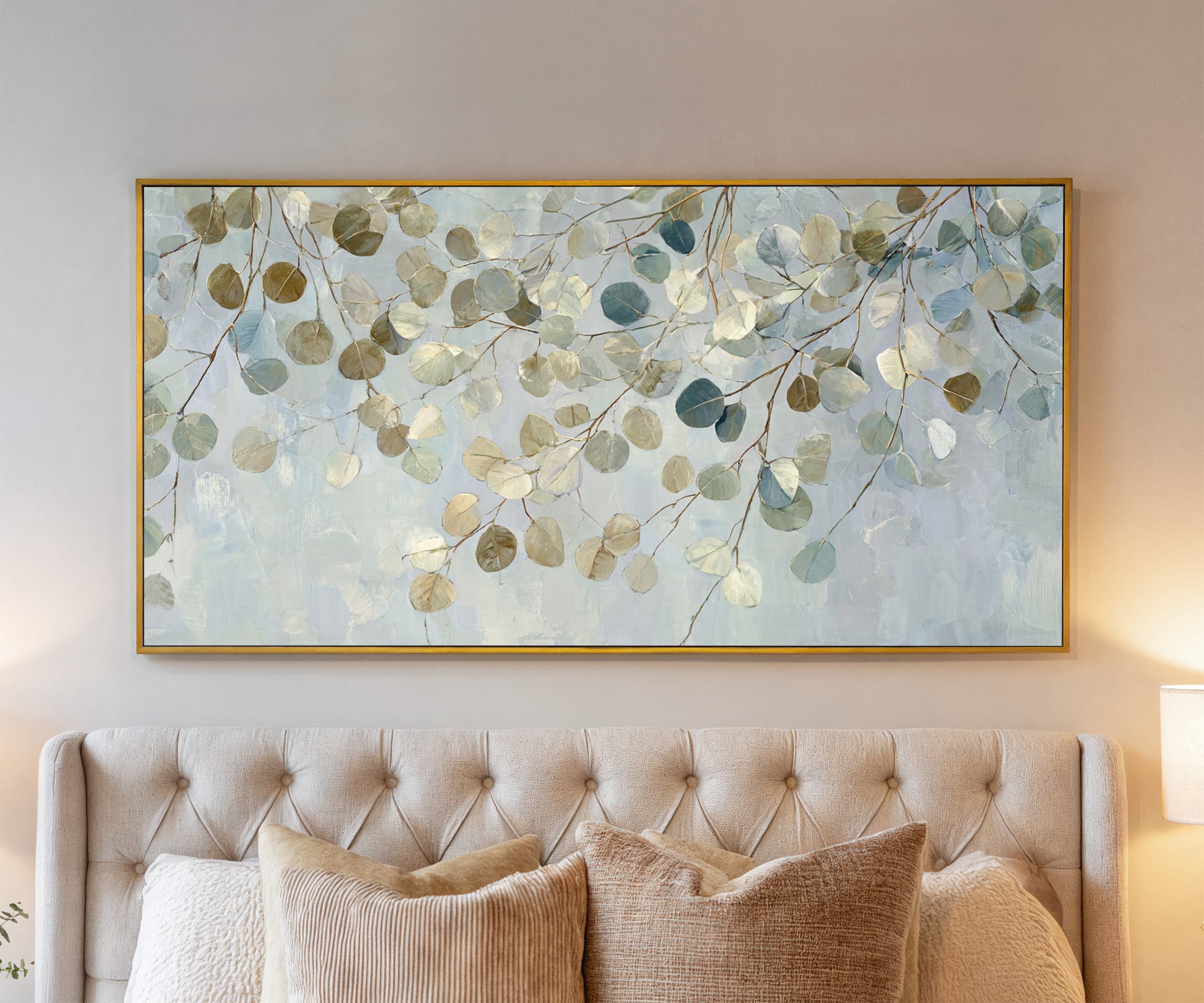 pale eucalyptus leaves on thin branching stems canvas wall art in a gold frame above a bed
