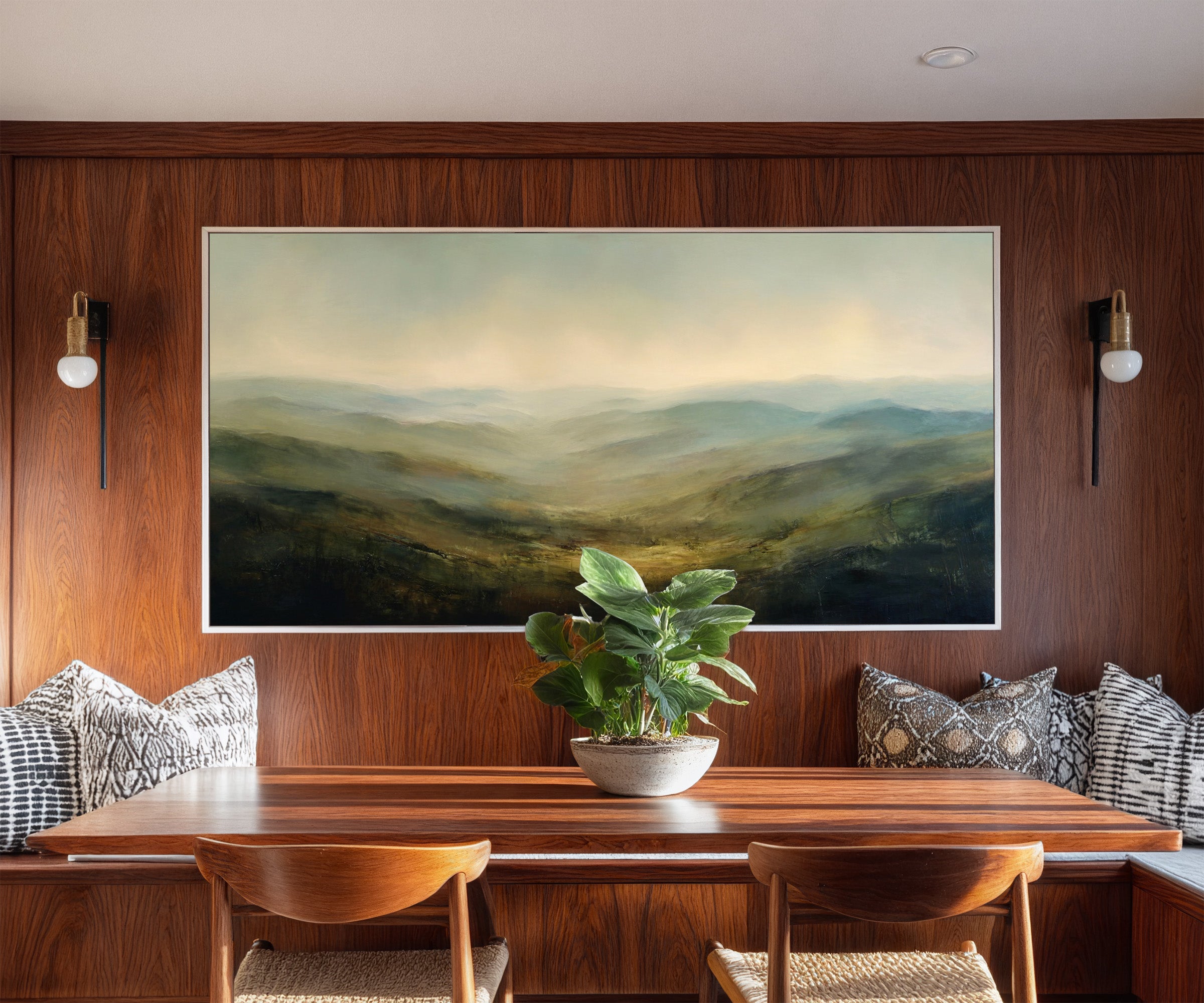 soft blue green ridgelines with a bright canvas wall art in a white frame in a styled room setting