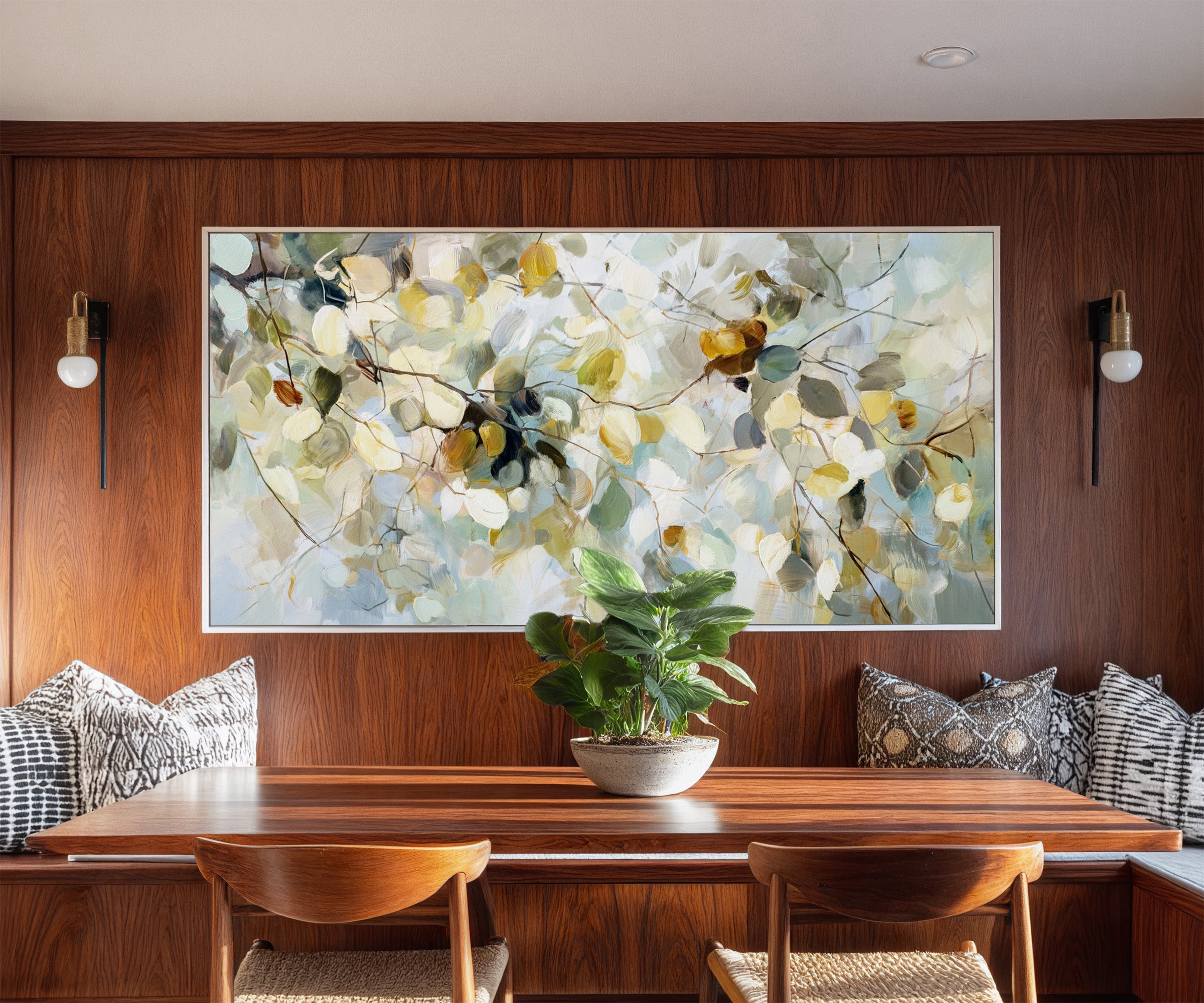 soft blue, cream, and gold leaf branch canvas wall art in a white frame in a styled room setting