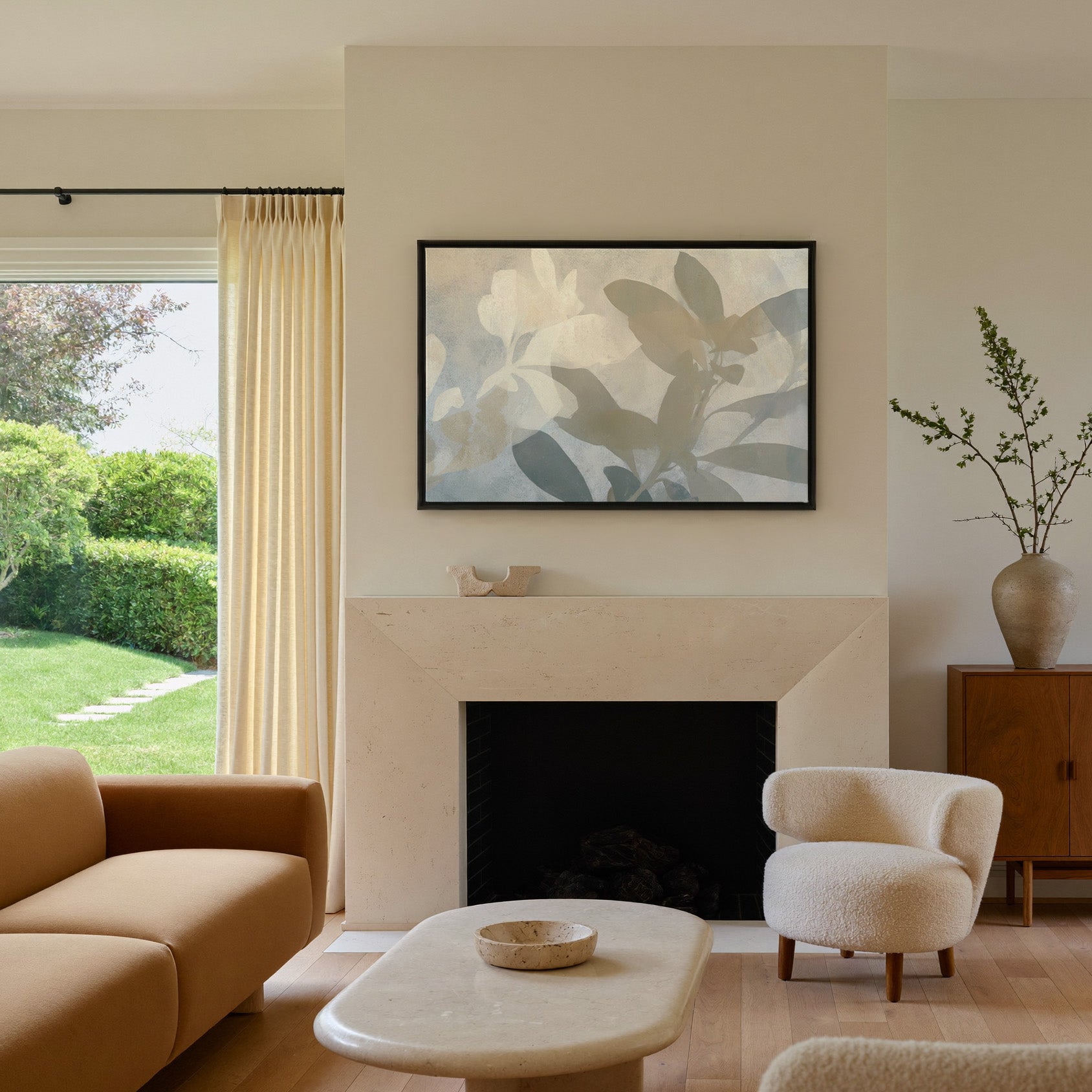 soft beige and gray leaf branch abstract canvas wall art in a black frame above a mantel