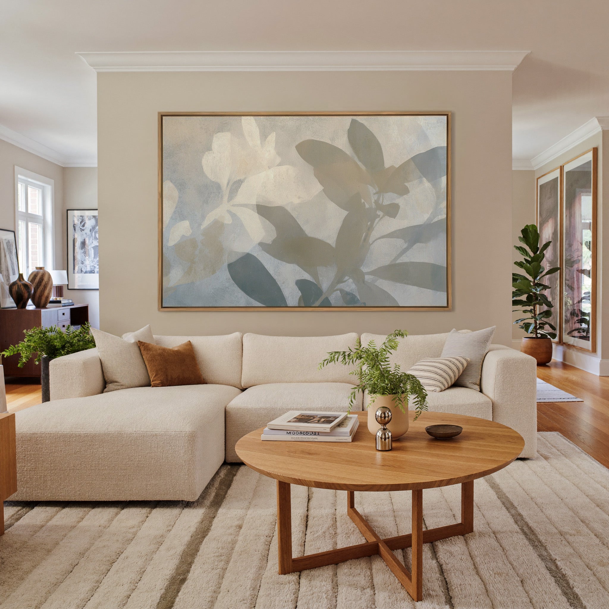soft beige and gray leaf branch abstract canvas wall art in an oak frame in a living room