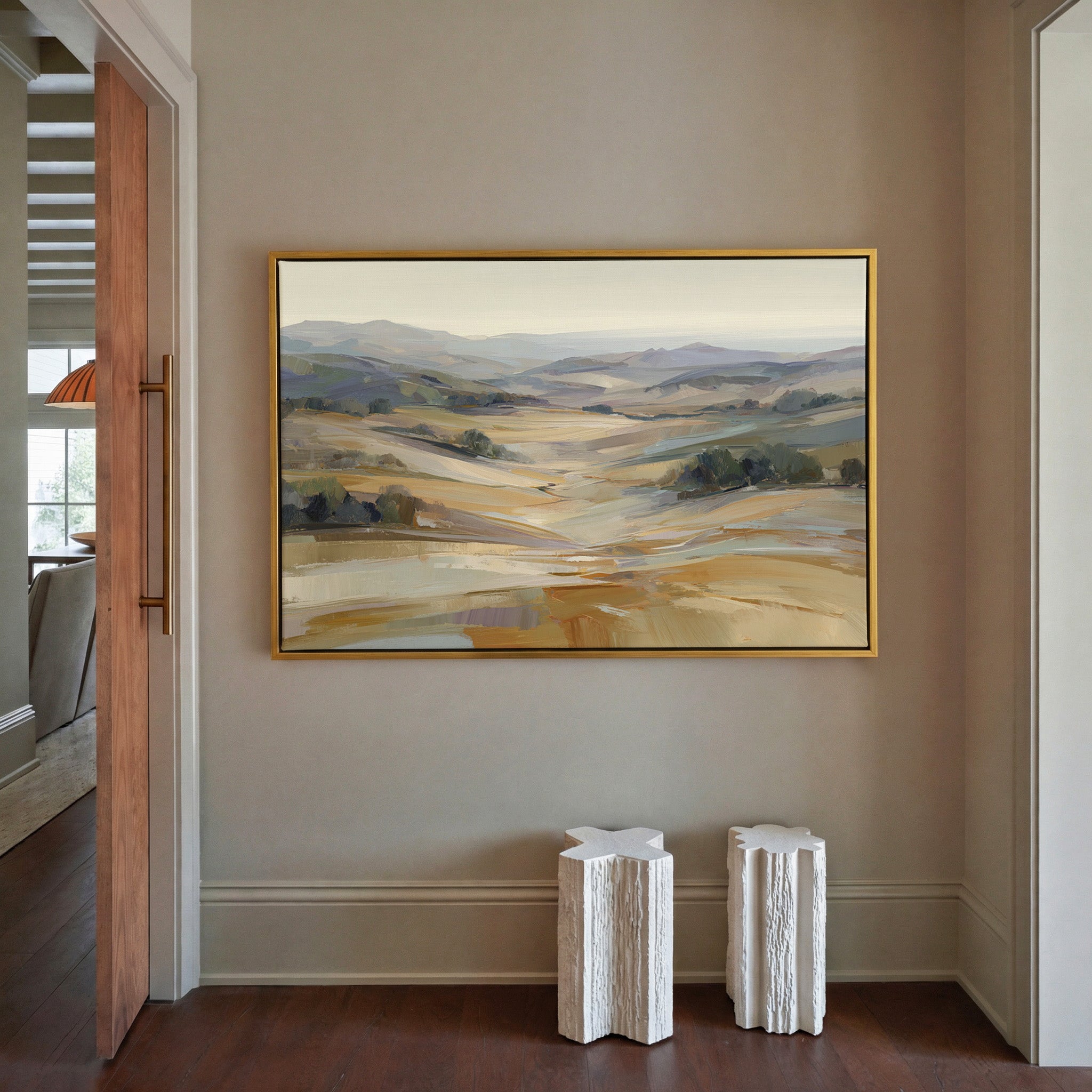 pale rolling hills and valley in cream, gold, canvas wall art in a gold frame in a styled room setting