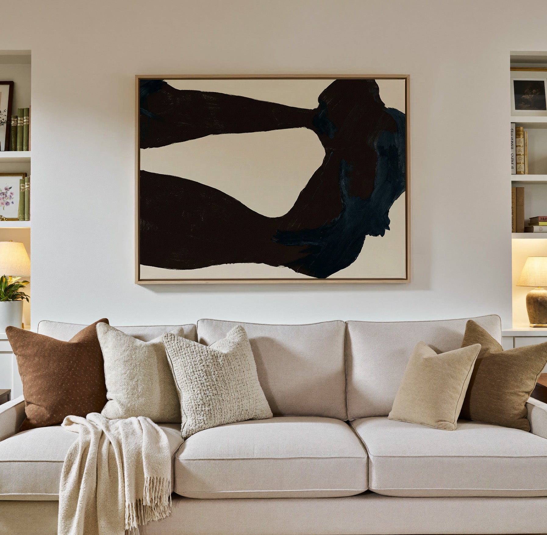 dark charcoal and deep blue canvas wall art in a natural wood frame in a styled room setting
