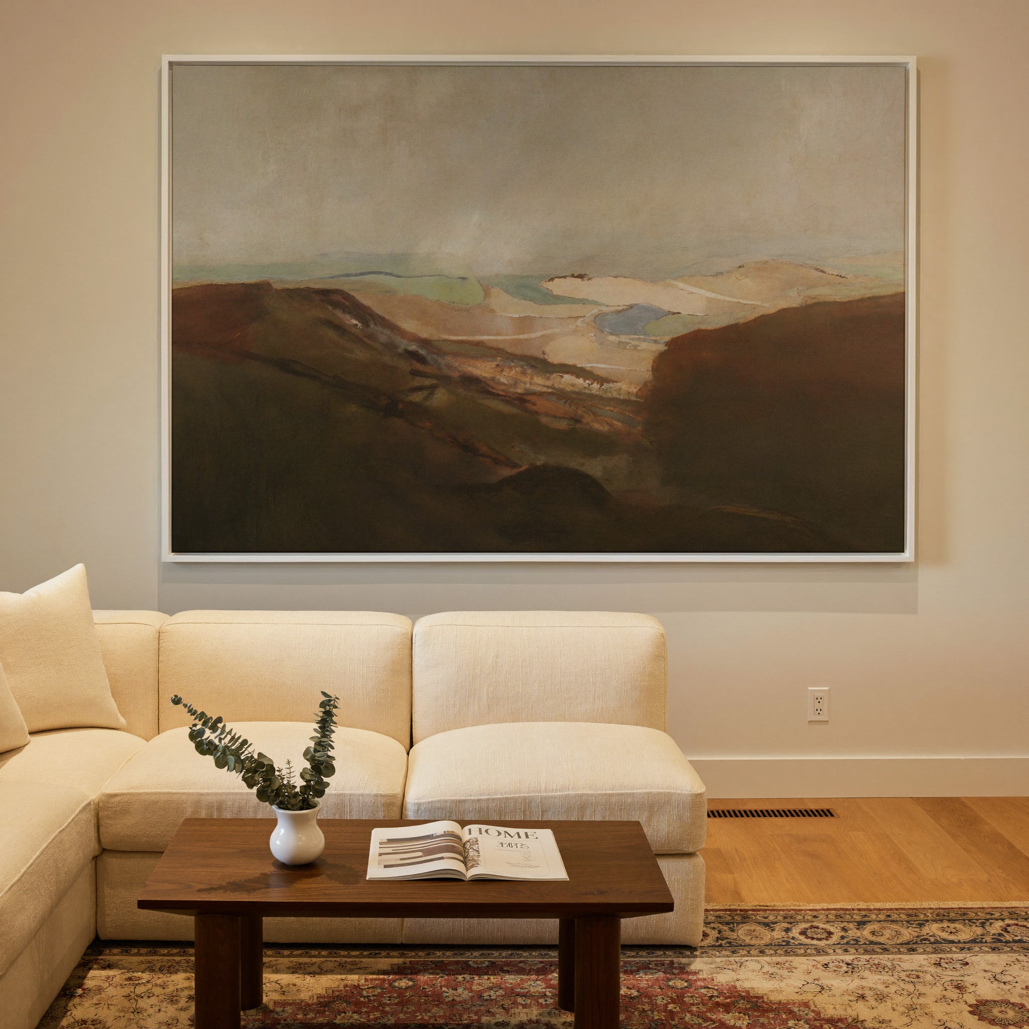 soft desert landscape with layered dunes and a canvas wall art in a white frame in a styled room setting