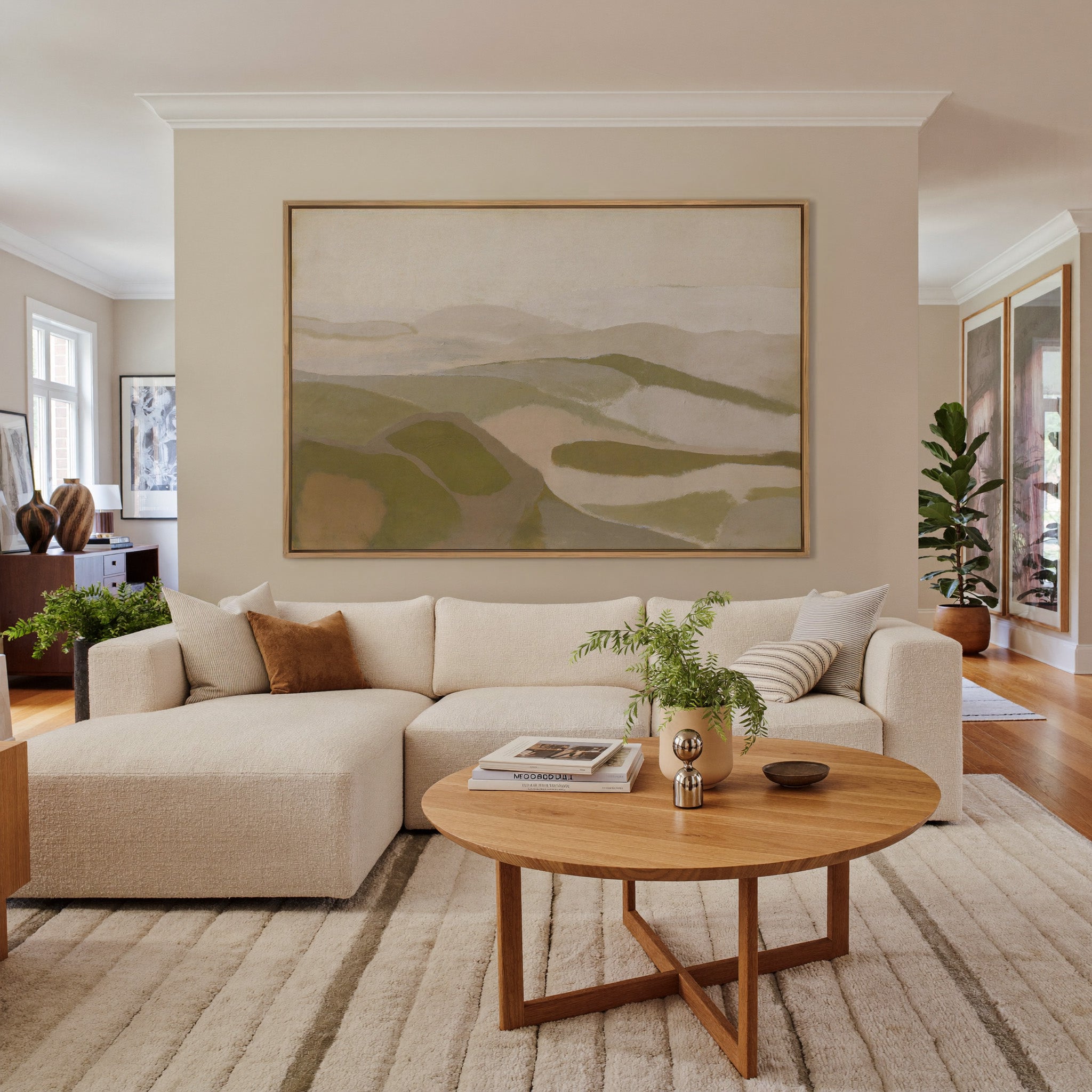 soft beige and olive abstract with layered canvas wall art in an oak frame in a living room