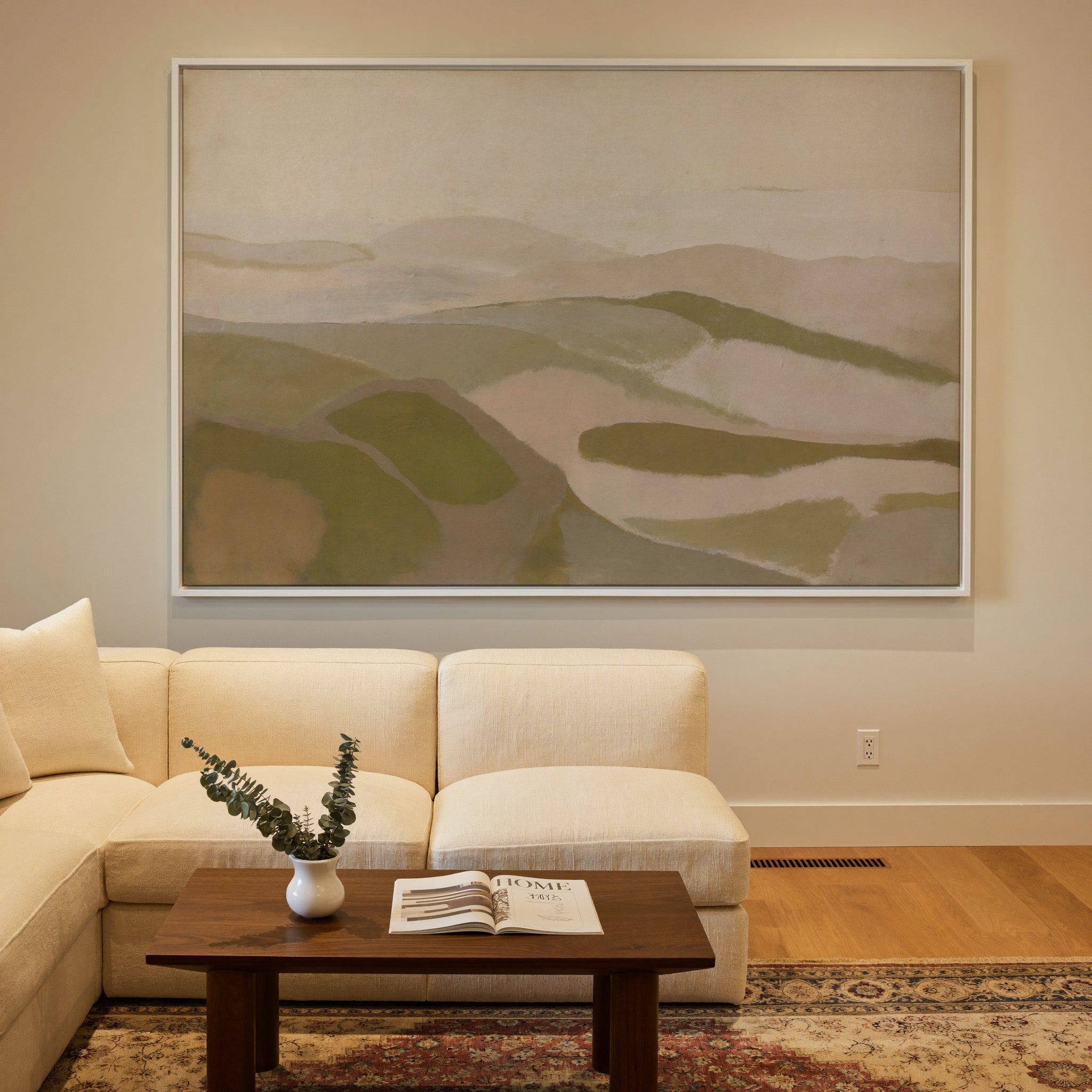 soft beige and olive abstract with layered canvas wall art in a white frame in a styled room setting