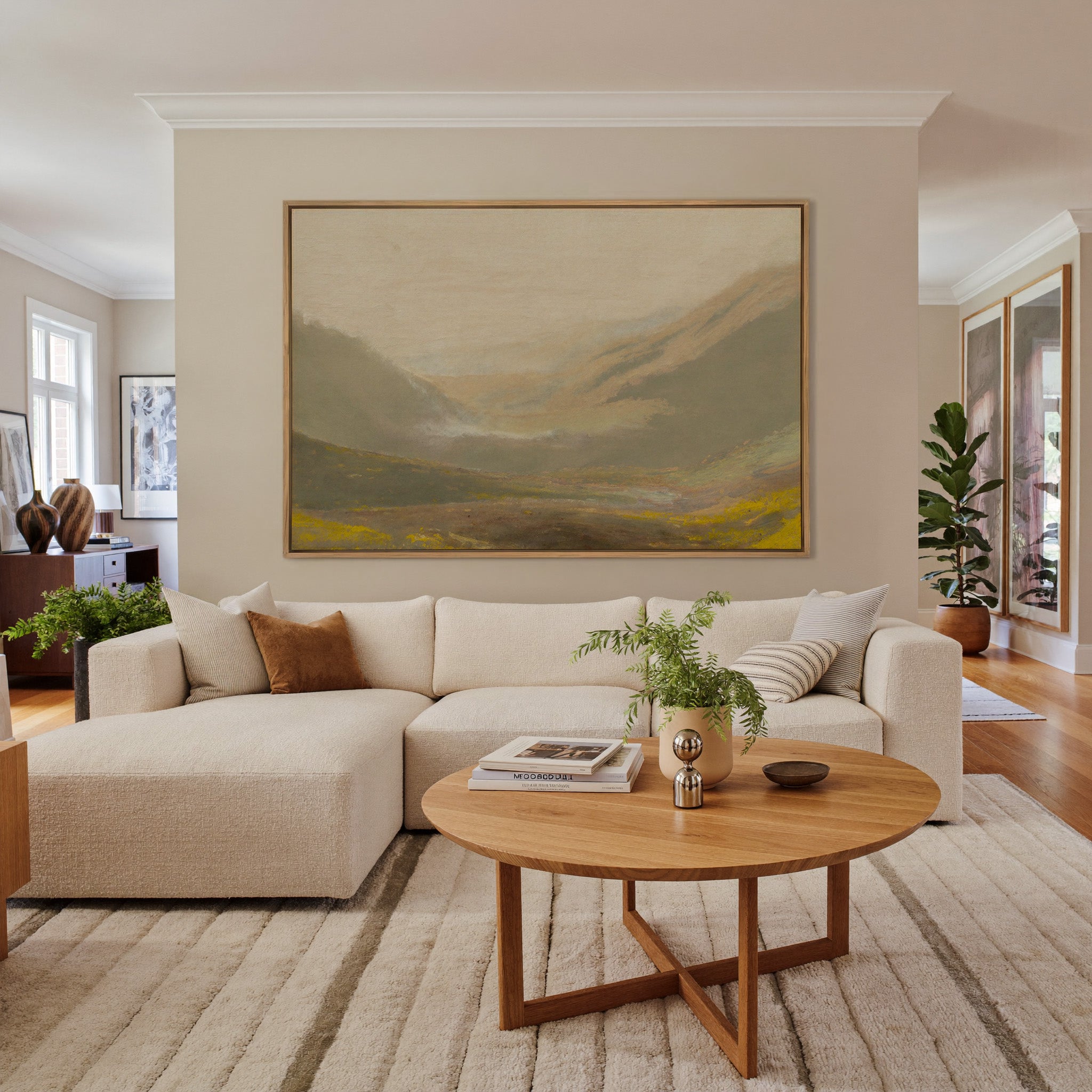 misty valley landscape with ochre hills and a canvas wall art in an oak frame in a living room
