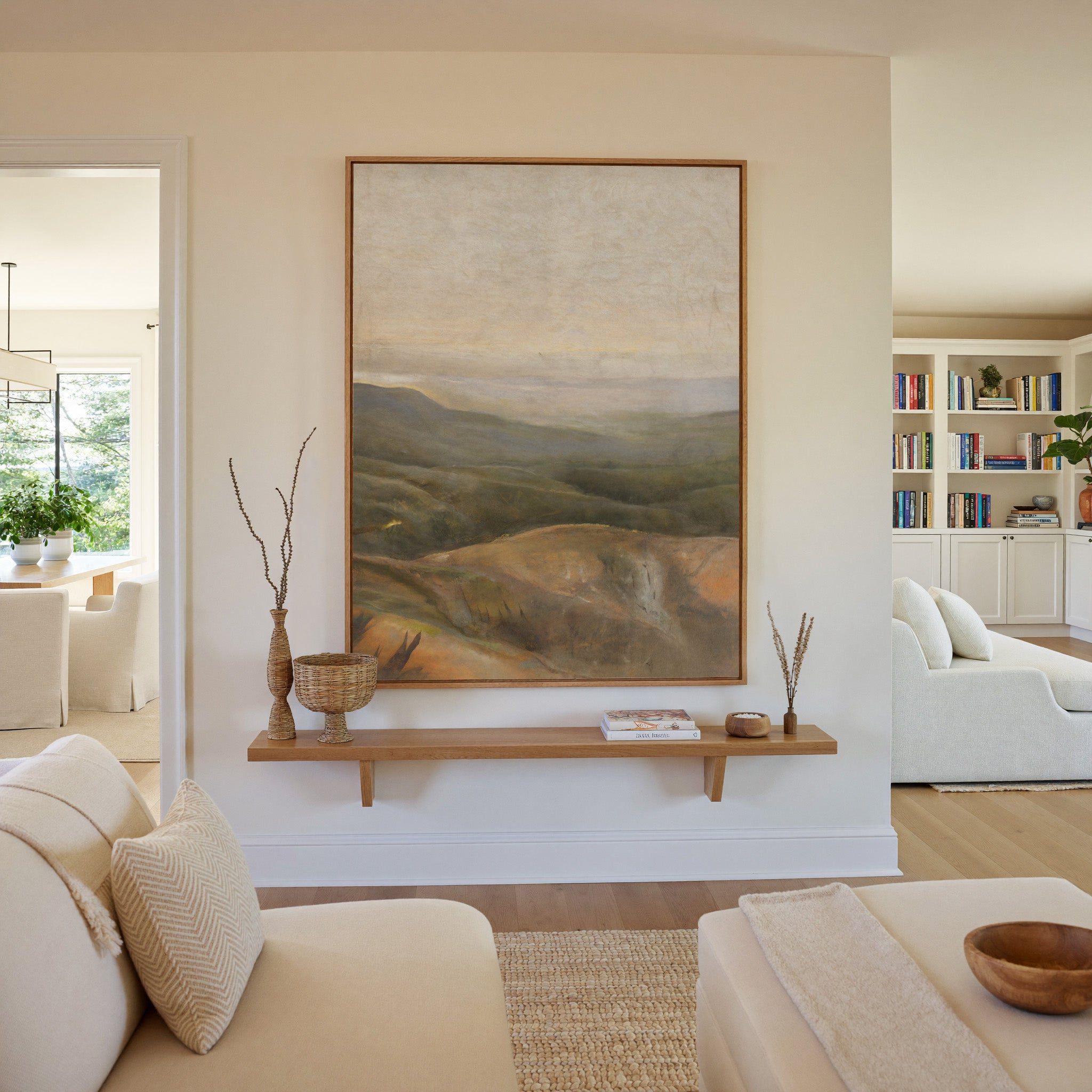 soft beige sky over layered olive and ochre canvas wall art in an oak frame in a living room