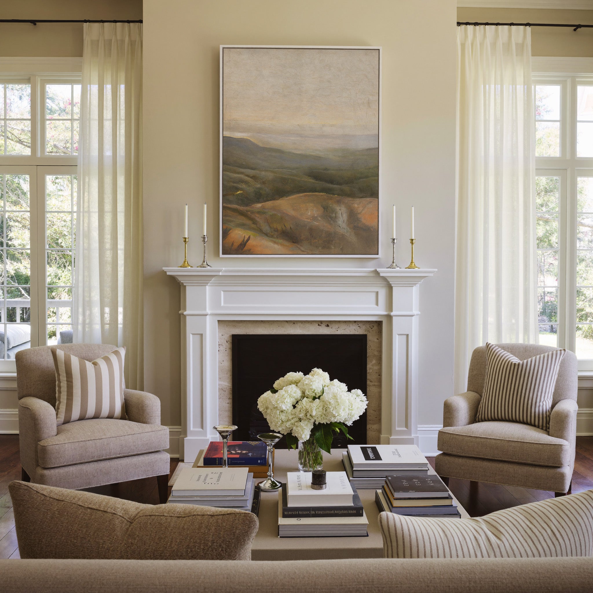 soft beige sky over layered olive and ochre canvas wall art in a white frame above a mantel