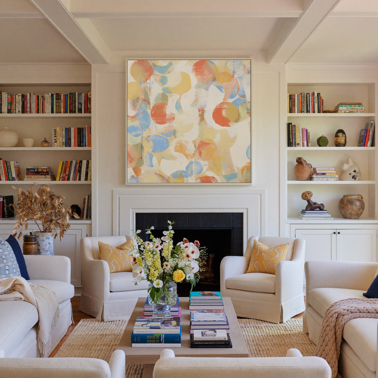 soft pastel circle abstract canvas wall art in a white frame above a fireplace
