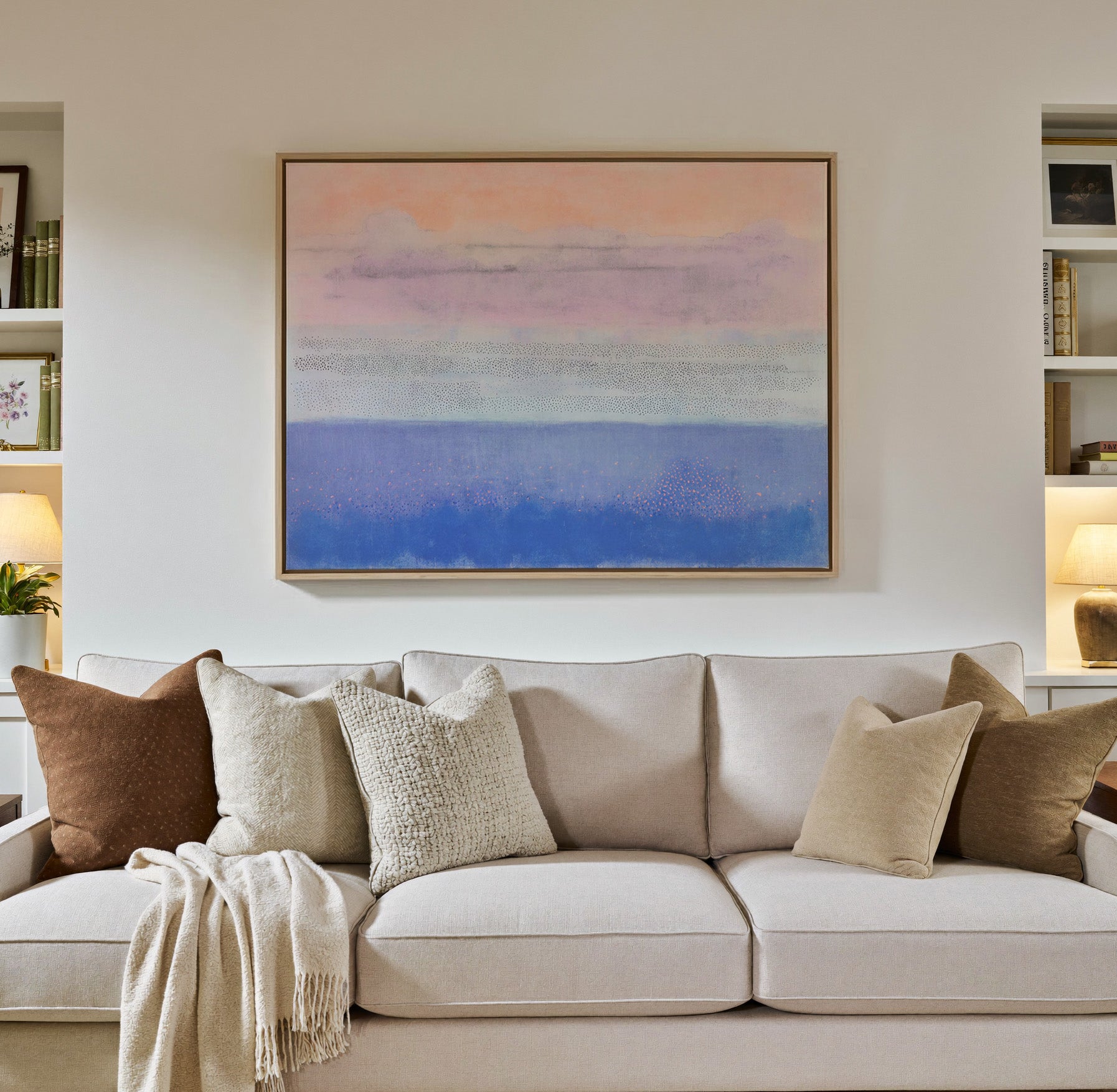 soft peach, lavender, and blue abstract canvas wall art in a natural wood frame in a styled room setting