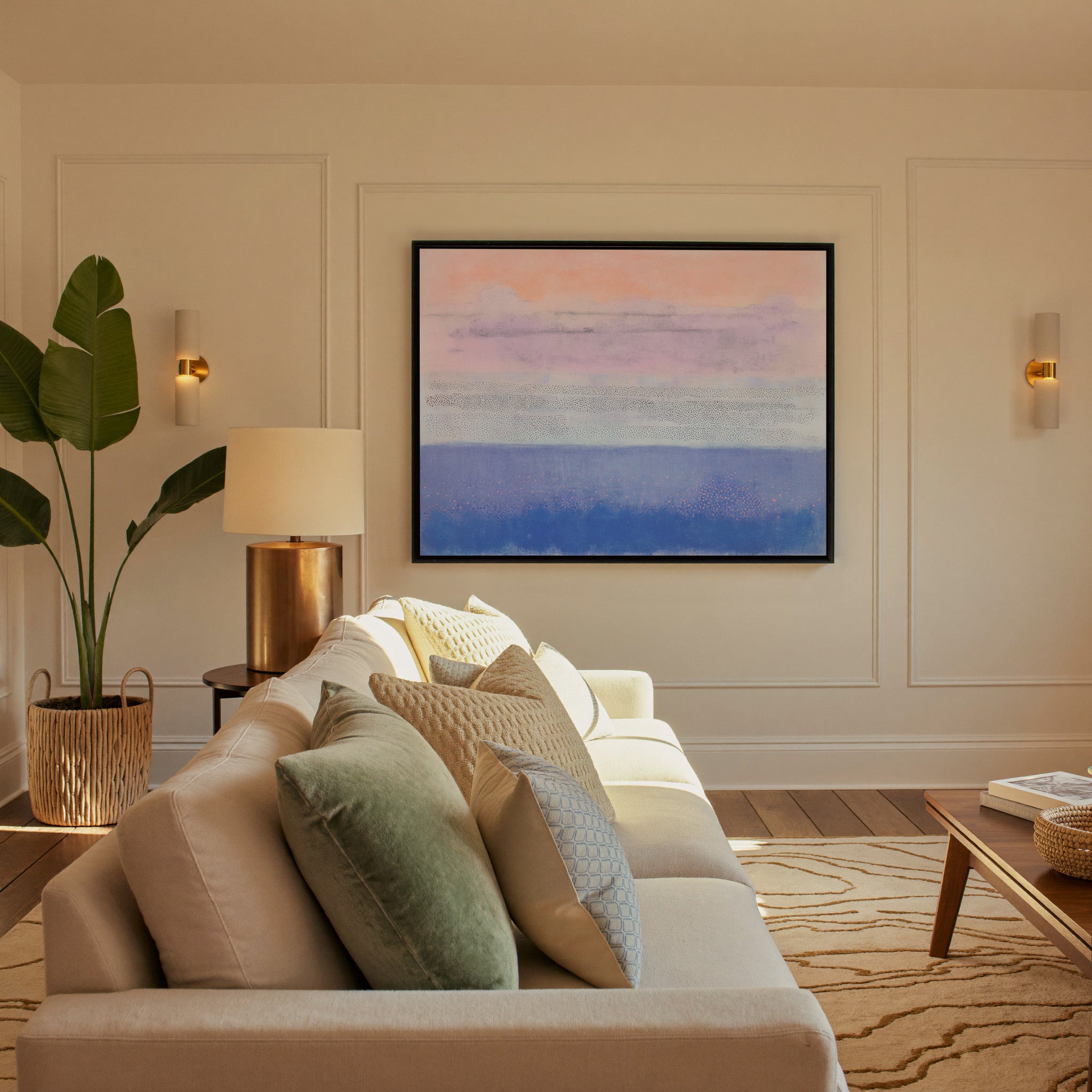 soft peach, lavender, and blue abstract canvas wall art in a black frame in a styled room setting