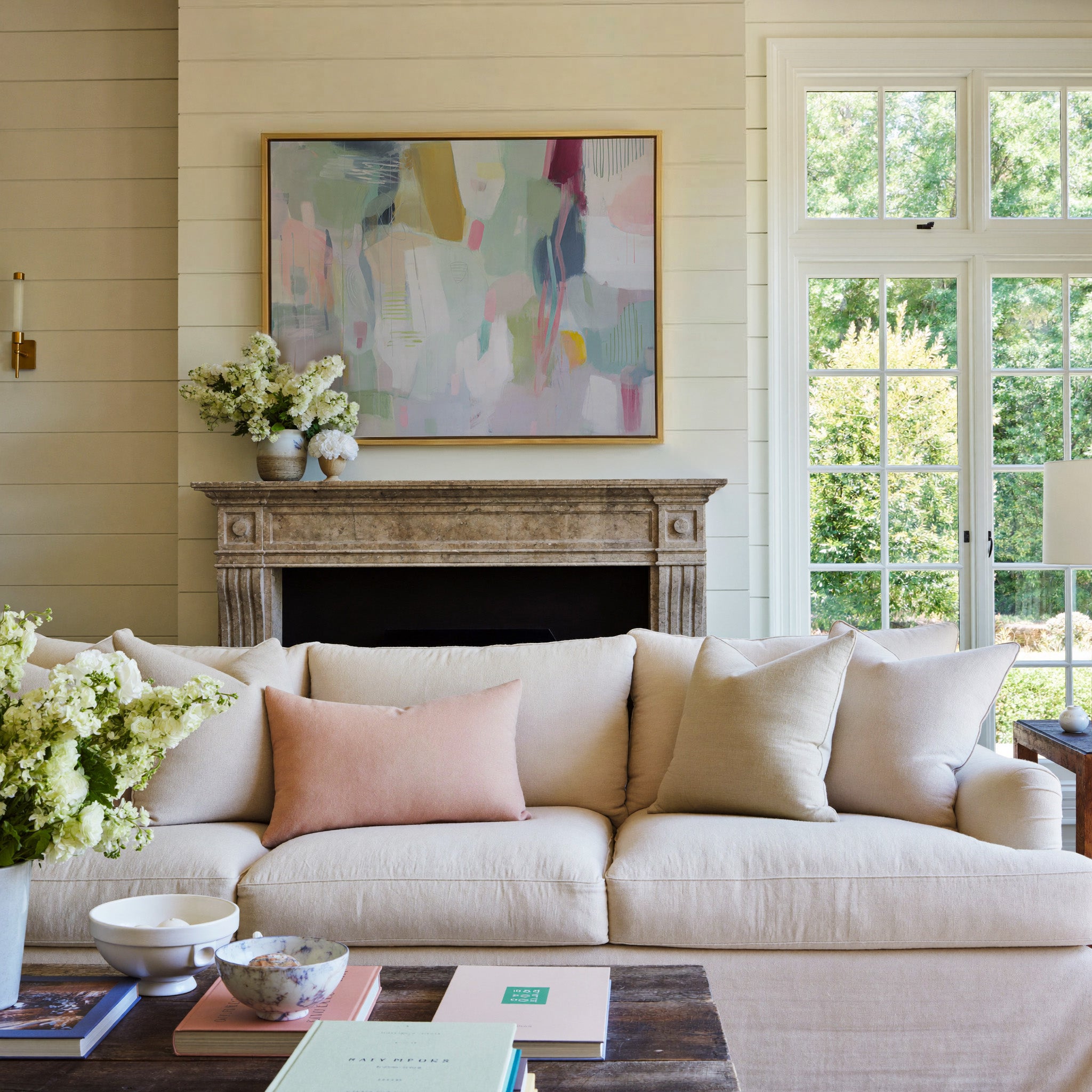 soft pastel abstract with vertical marks and canvas wall art in a gold frame above a mantel