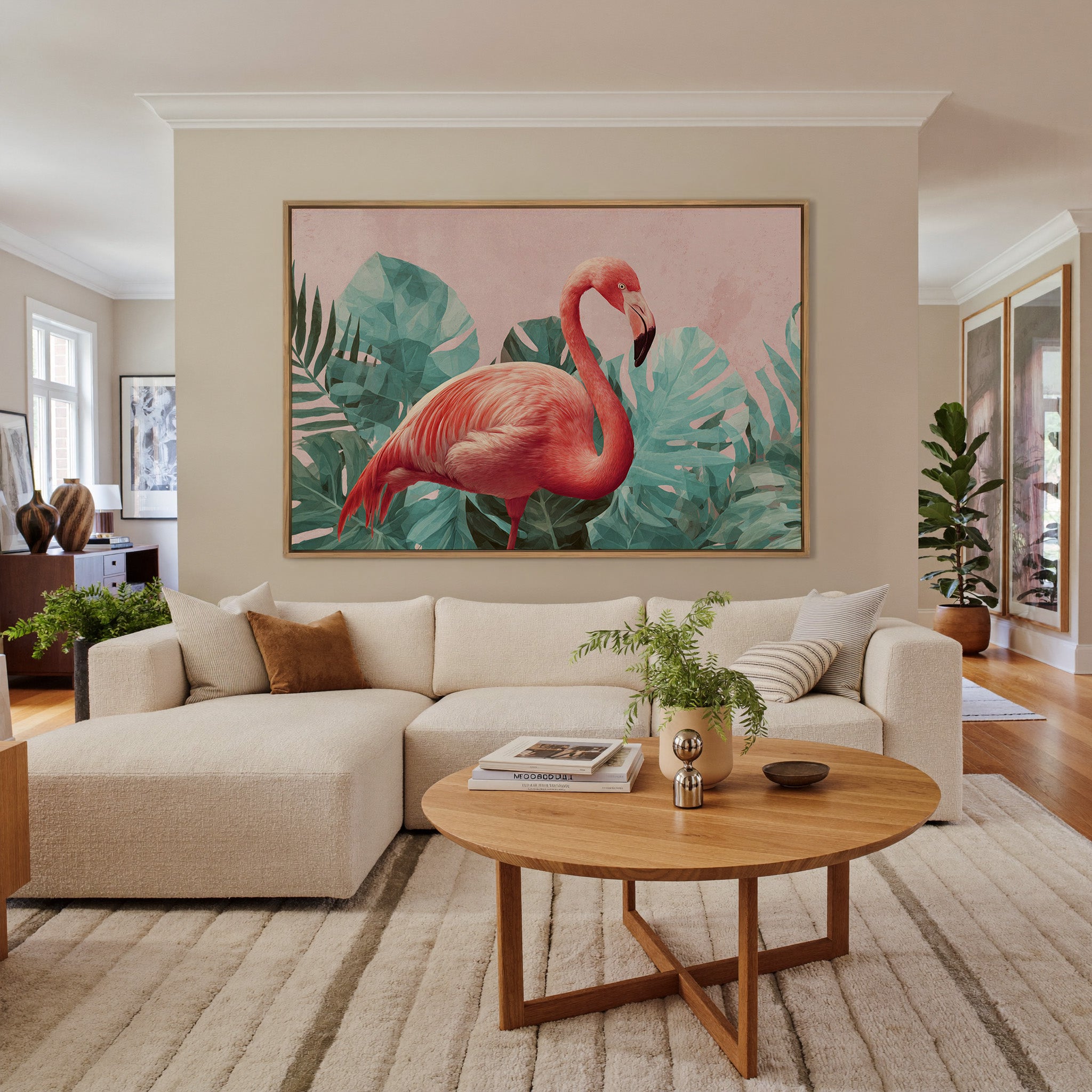 pink flamingo among teal tropical leaves canvas wall art in an oak frame in a living room