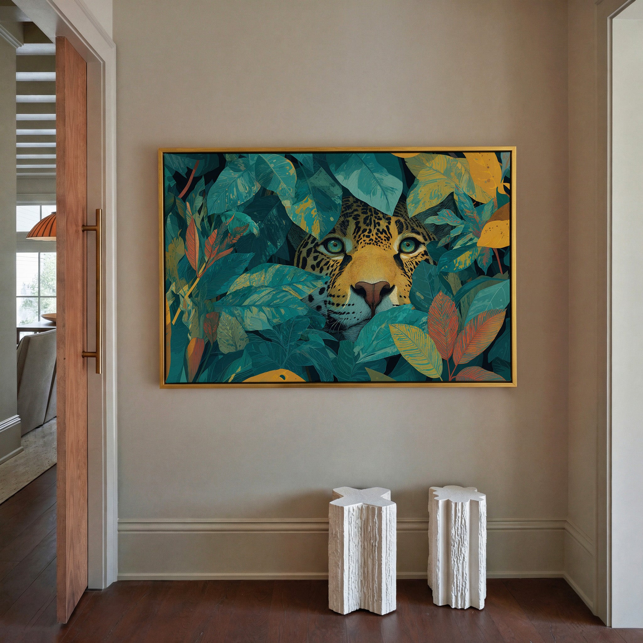 leopard face framed by teal leaves and gold canvas wall art in a gold frame in a styled room setting