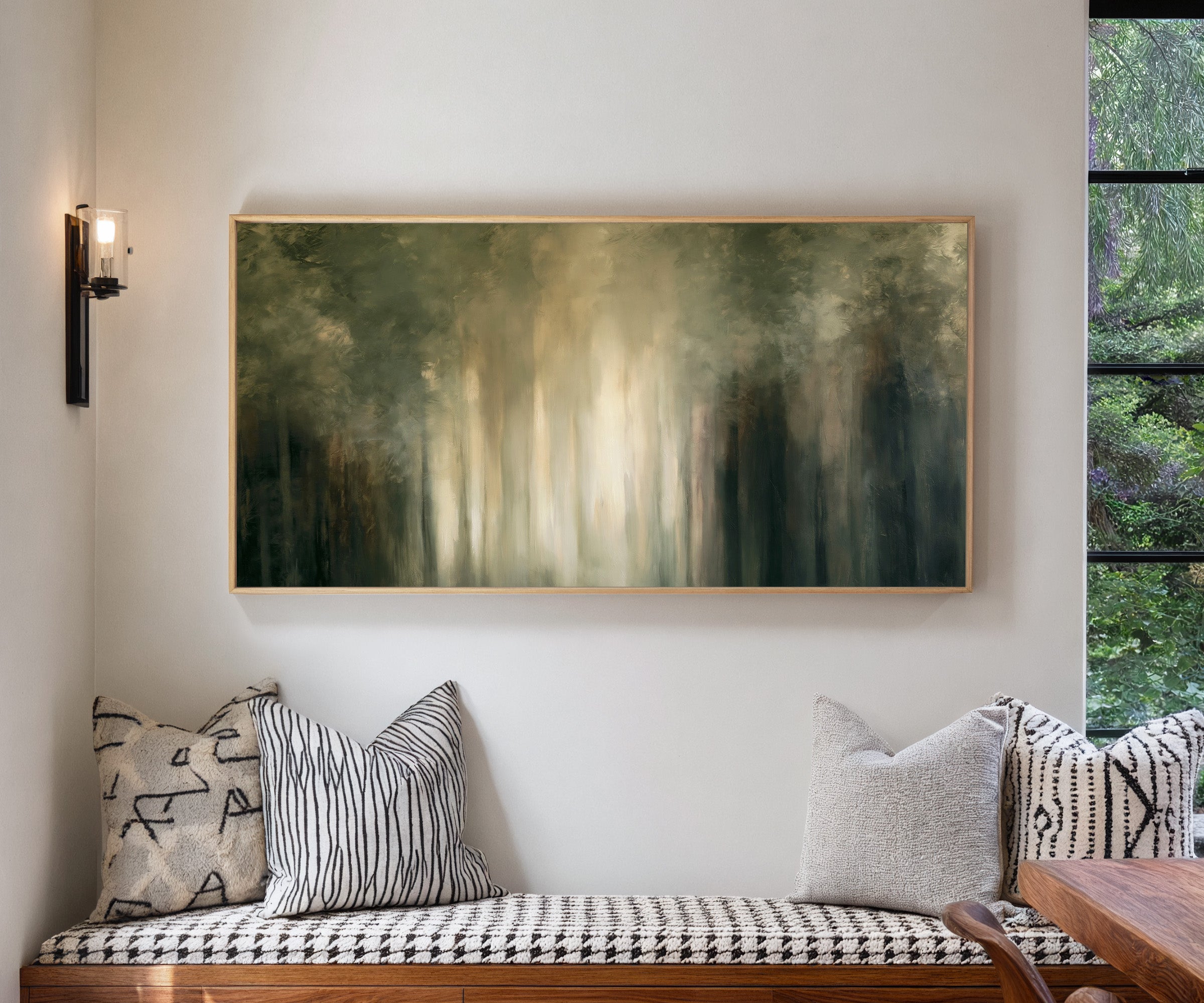 soft green and cream abstract forest with canvas wall art in a natural wood frame in a living room