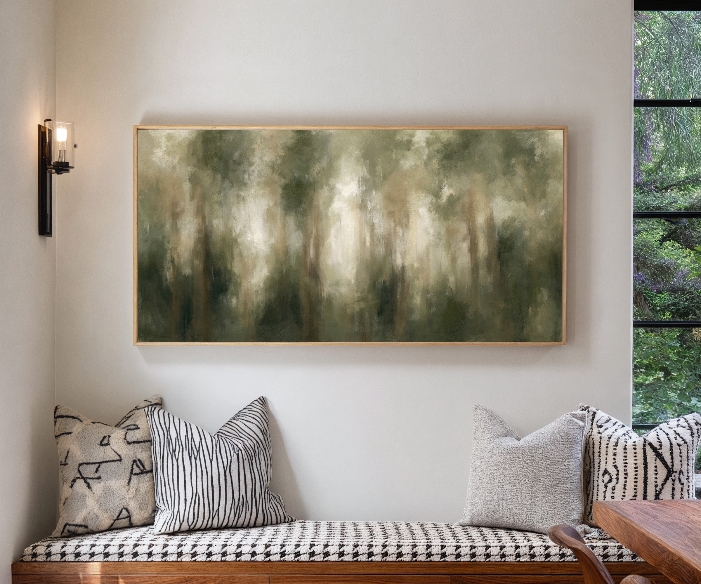 soft green and beige abstract forest canvas wall art in a natural wood frame in a living room