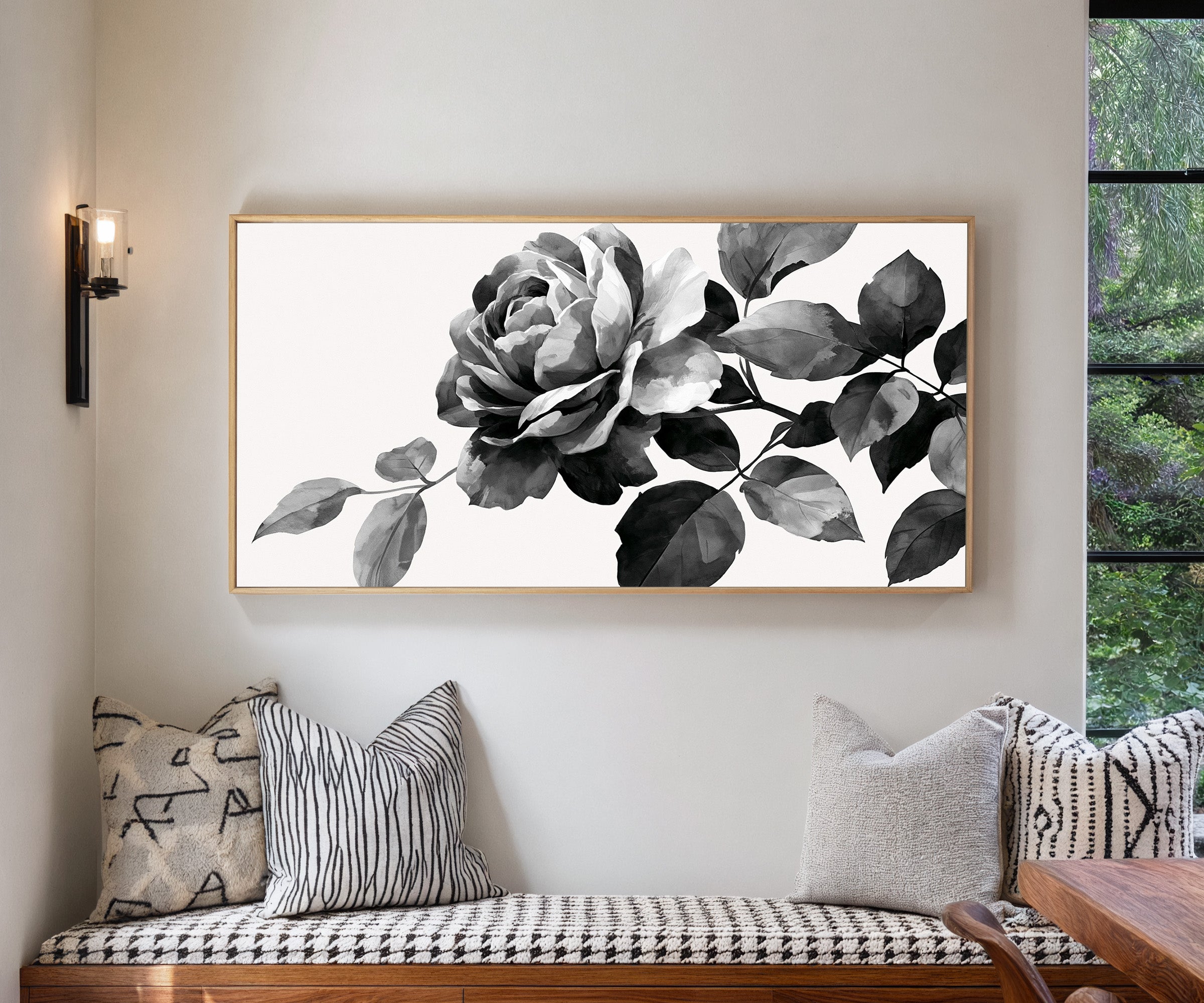 black and white floral branch canvas wall art in a natural wood frame in a living room