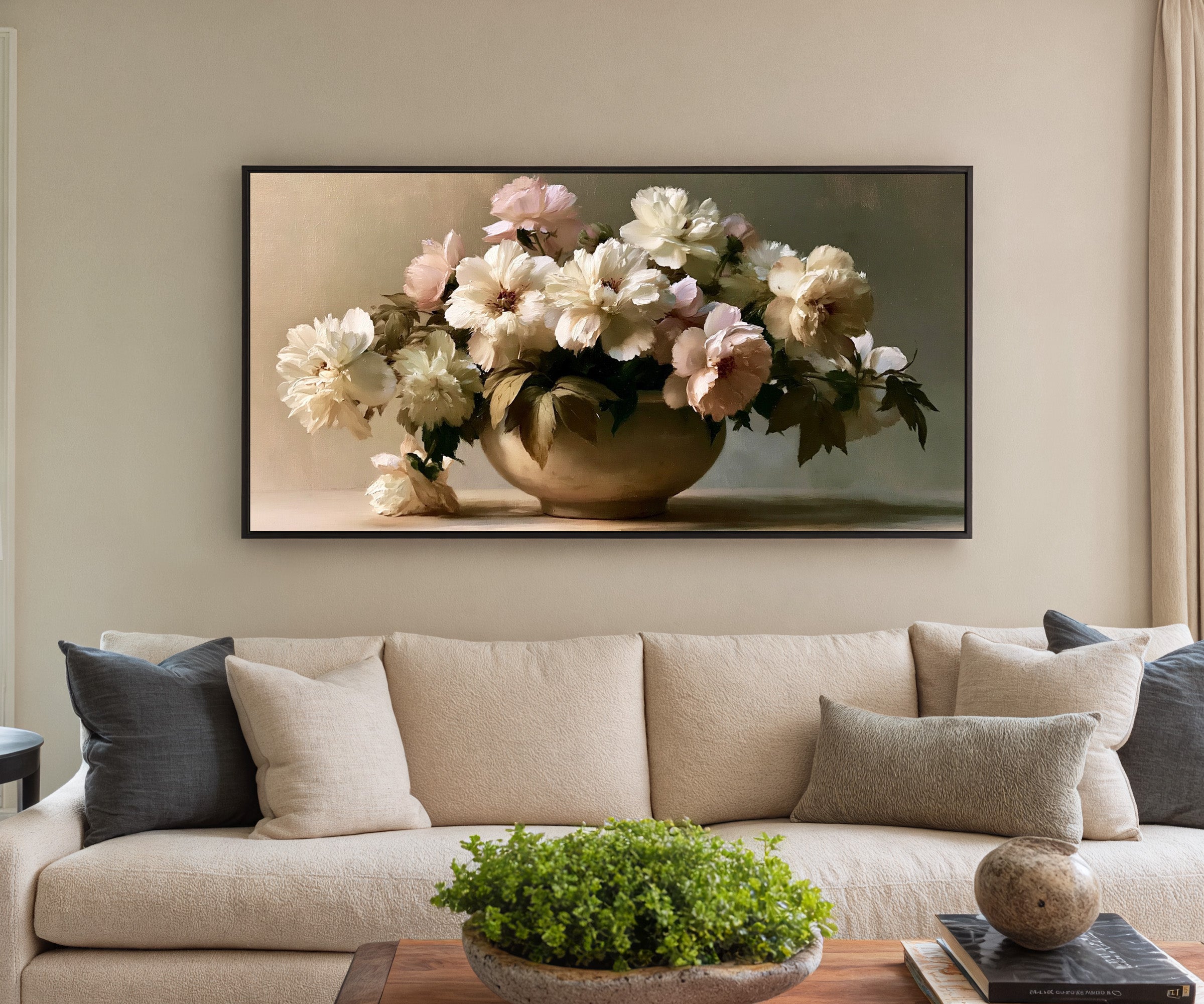 cream and pale blush floral still life canvas wall art in a black frame in a styled room setting