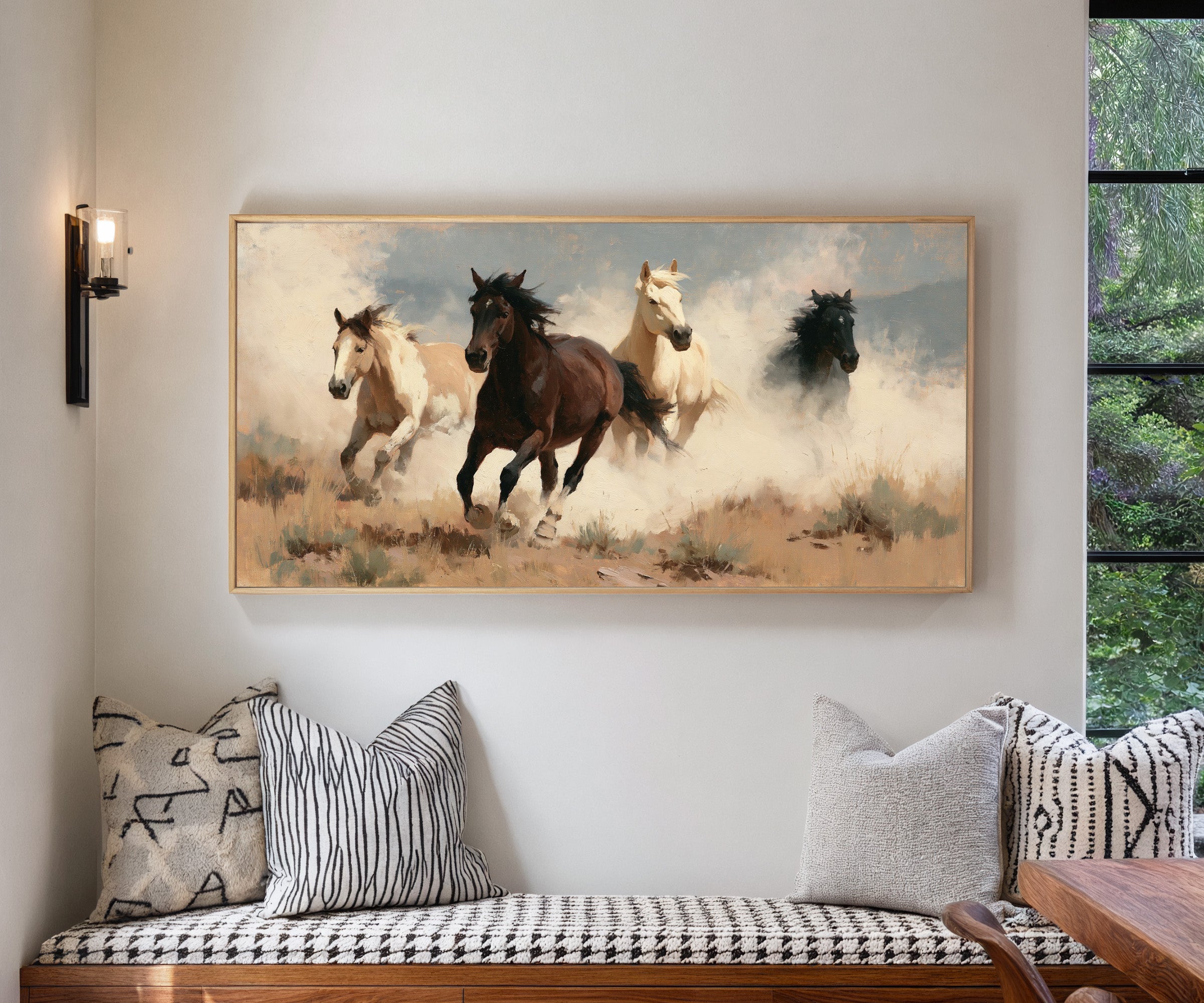 running horses in a dry open field with dust canvas wall art in a natural wood frame in a living room