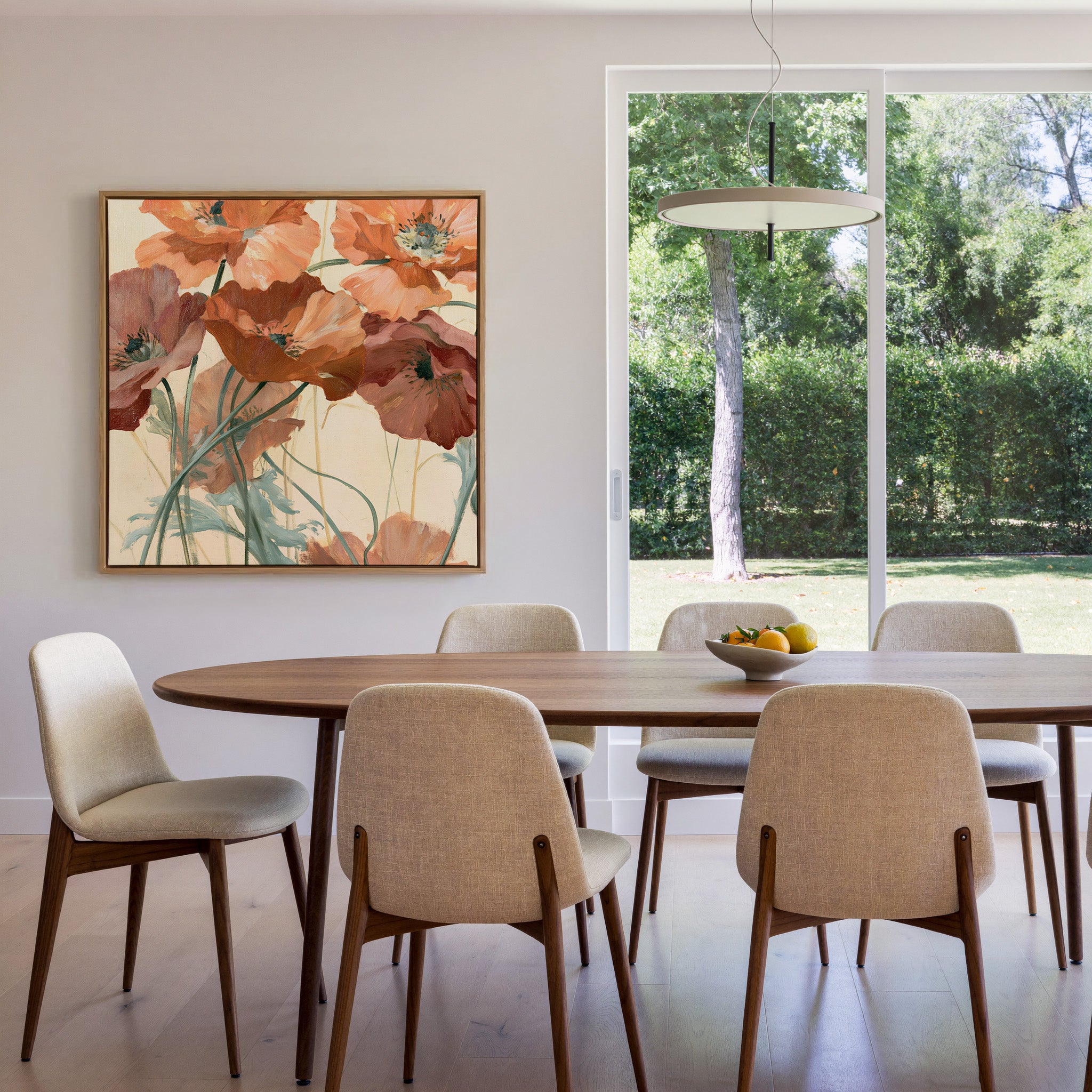 apricot and rust poppy flowers with thin green canvas wall art in an oak frame in a dining room
