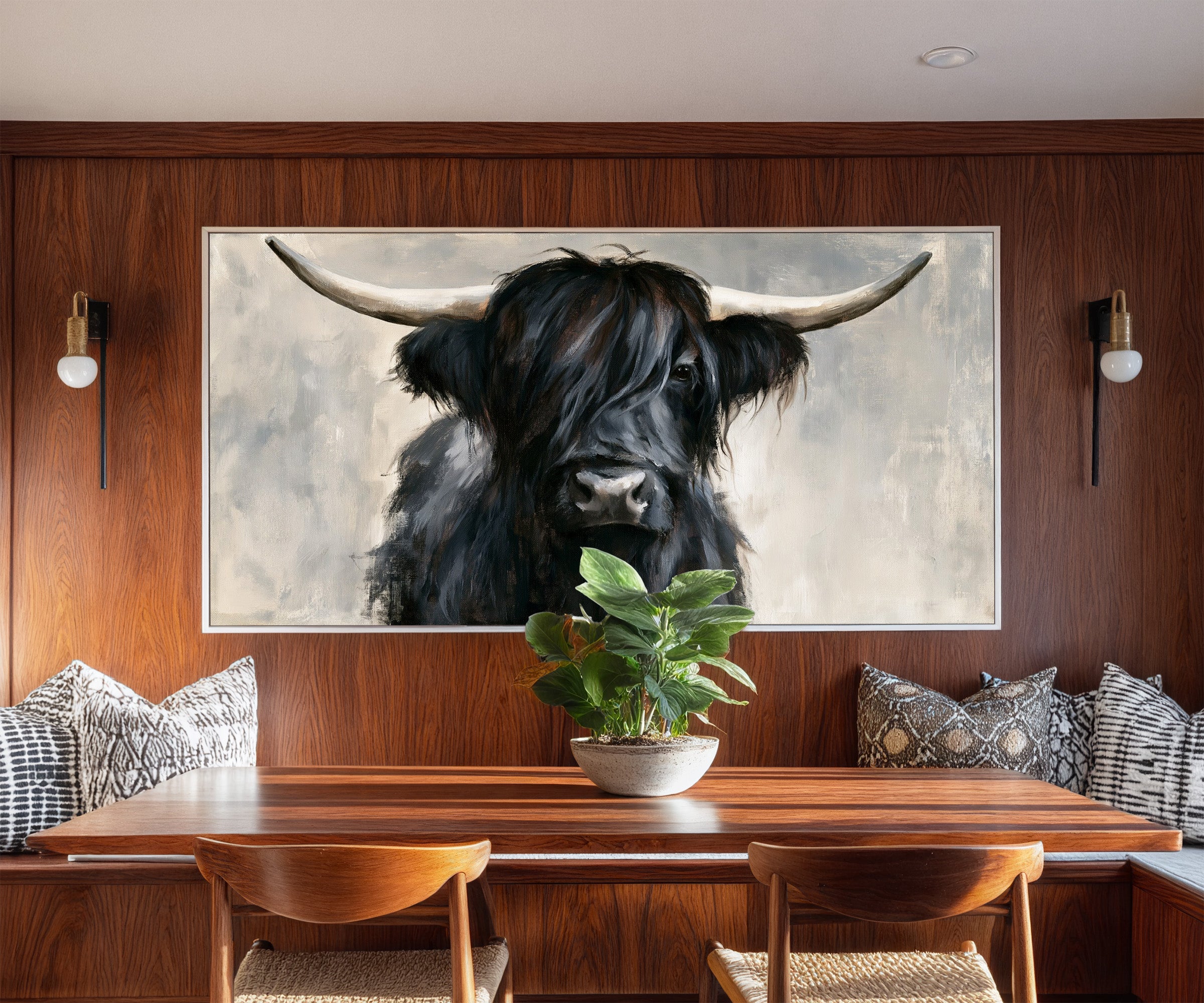black highland cow with long shaggy hair and canvas wall art in a white frame in a styled room setting