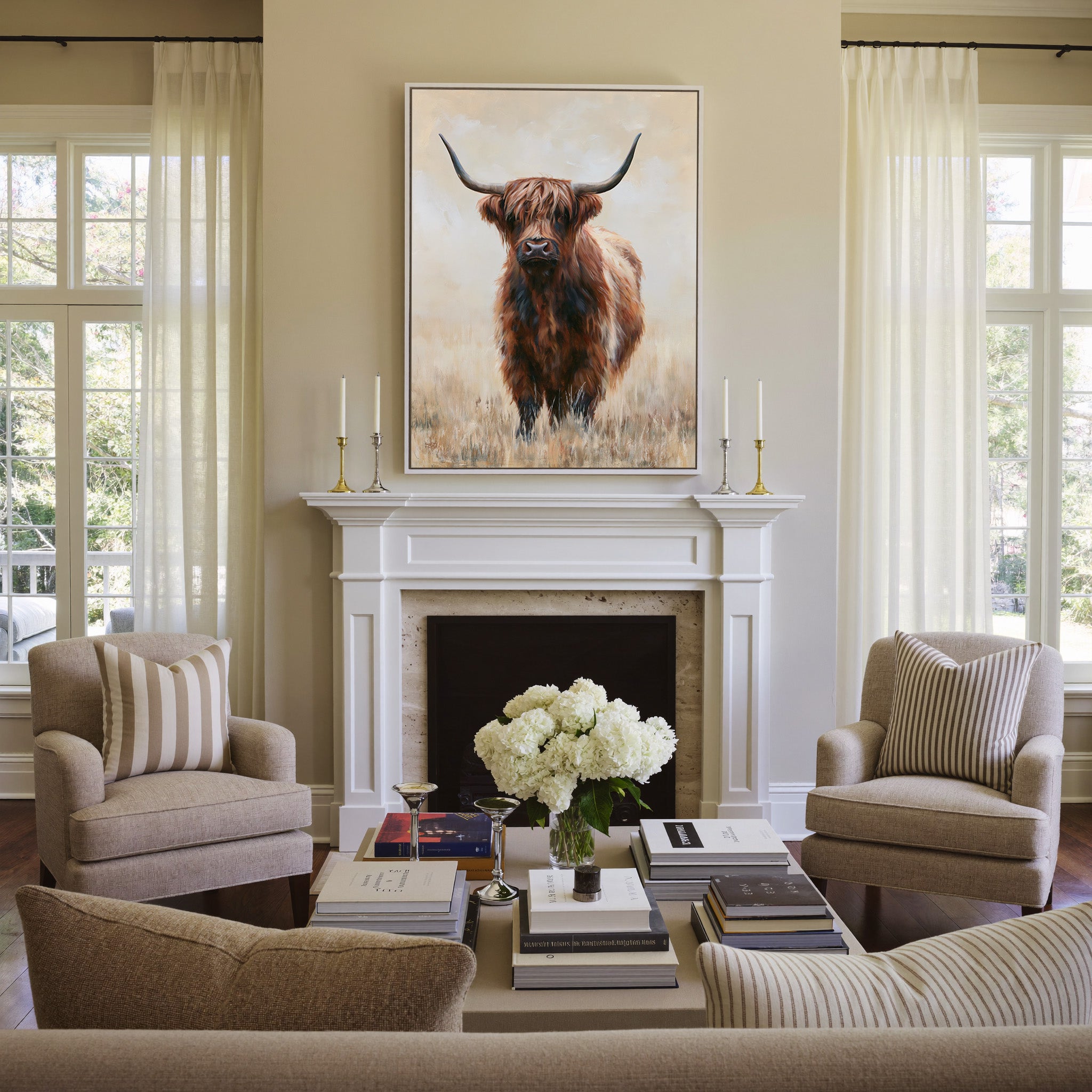 warm brown highland cow in pale dry grass canvas wall art in a white frame above a mantel