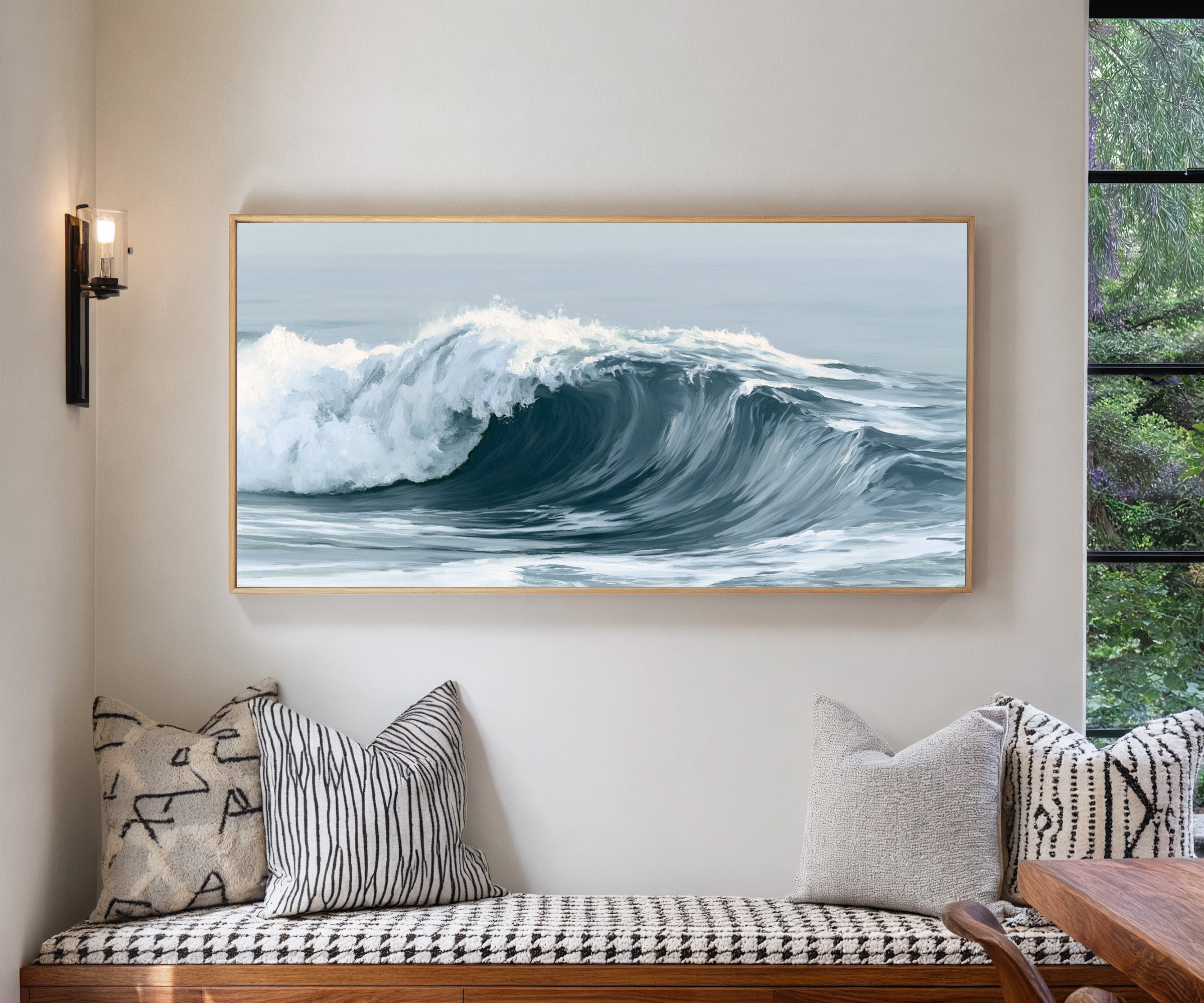 deep muted blue ocean wave canvas wall art in a natural wood frame in a living room