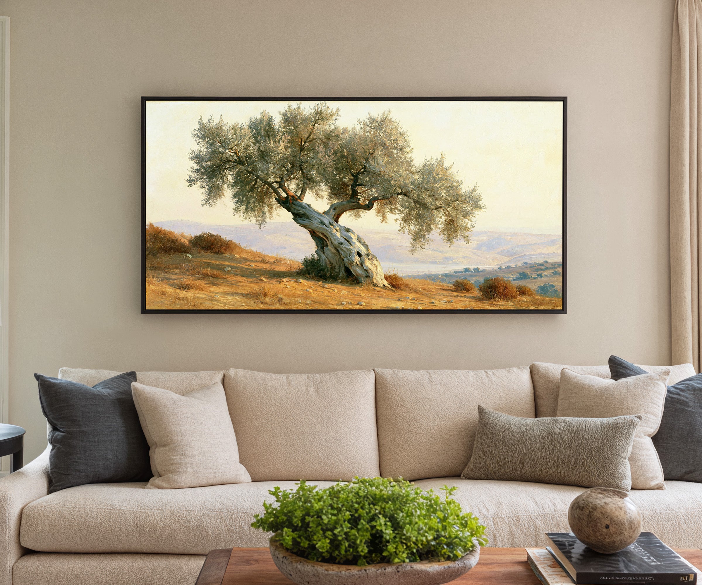 solitary olive tree on dry mediterranean hills canvas wall art in a black frame in a styled room setting