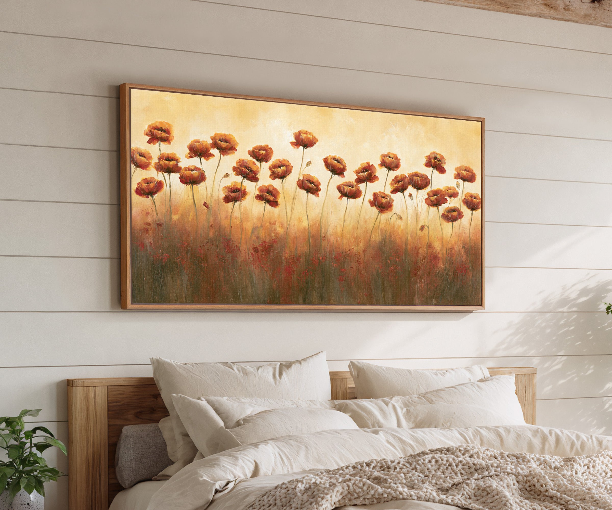 burnt orange poppy field canvas wall art in an oak frame above a bed, with clear frame and room context