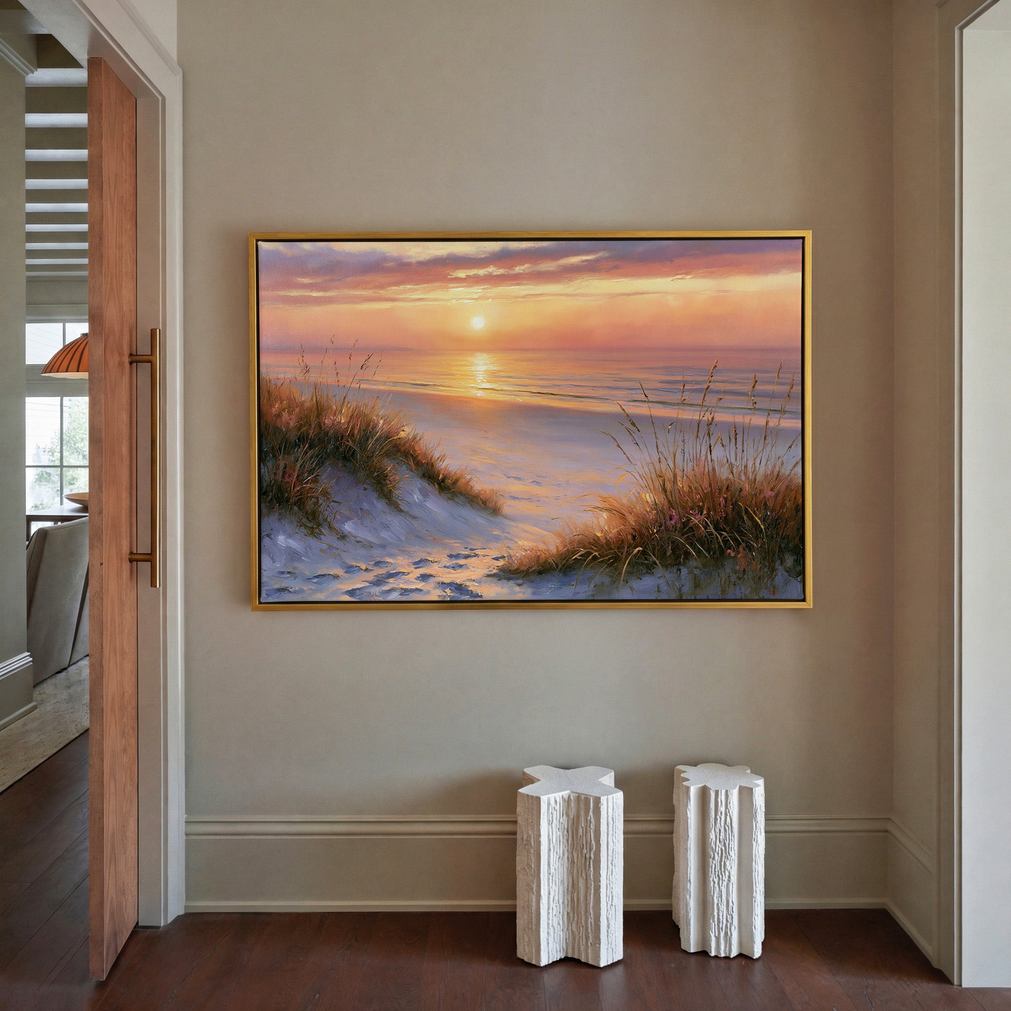 golden hour beach with dune grass and a calm sea canvas wall art in a gold frame in a styled room setting