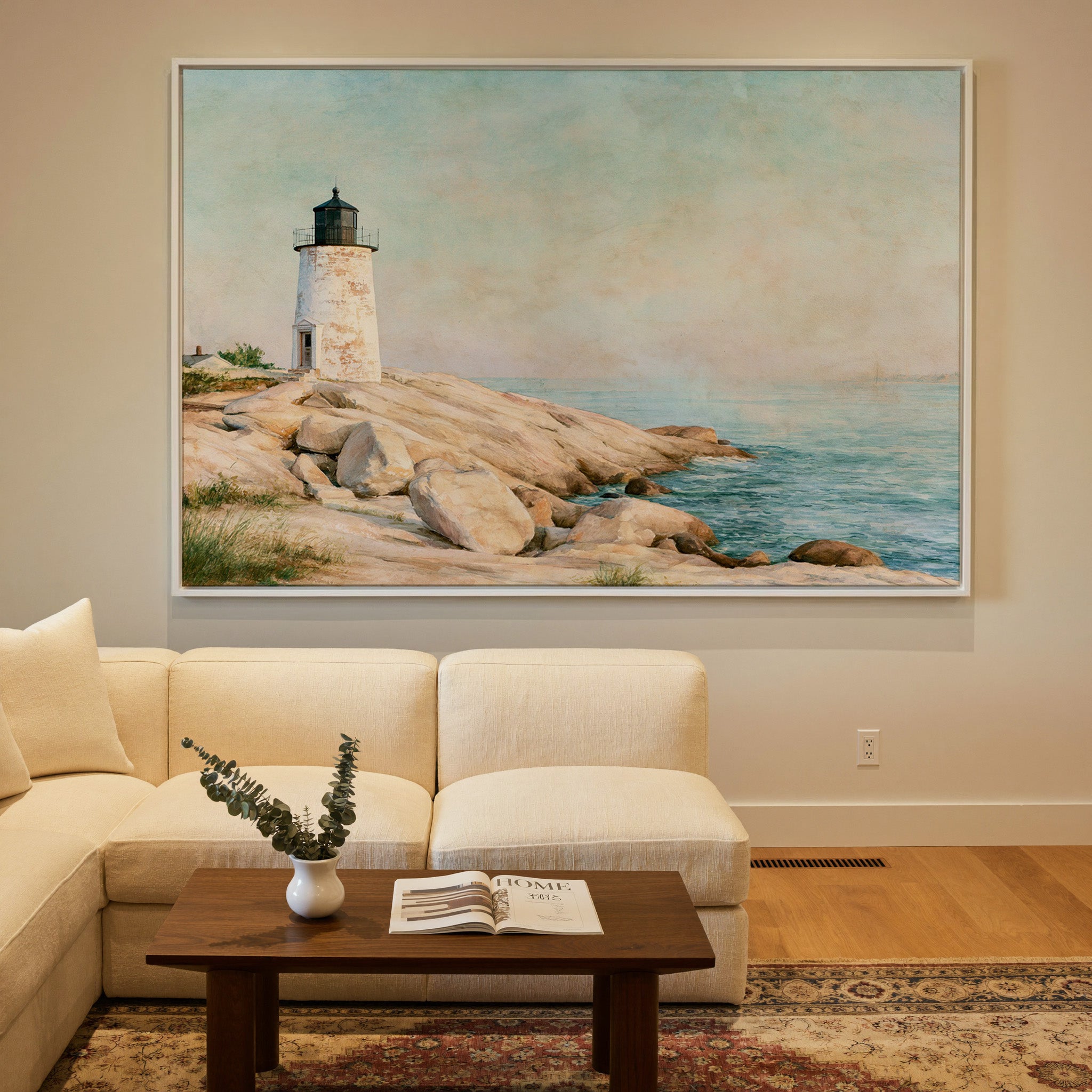 weathered white lighthouse on pale rock above canvas wall art in a white frame in a styled room setting