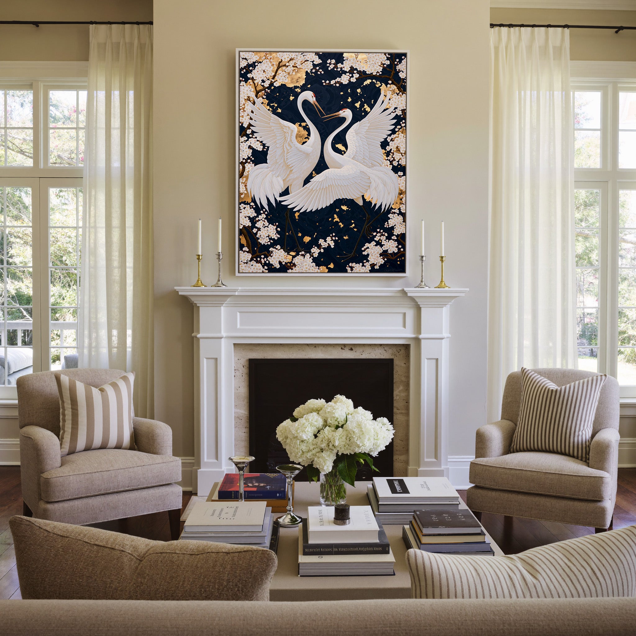 white crane pair among cherry blossoms on a canvas wall art in a white frame above a mantel