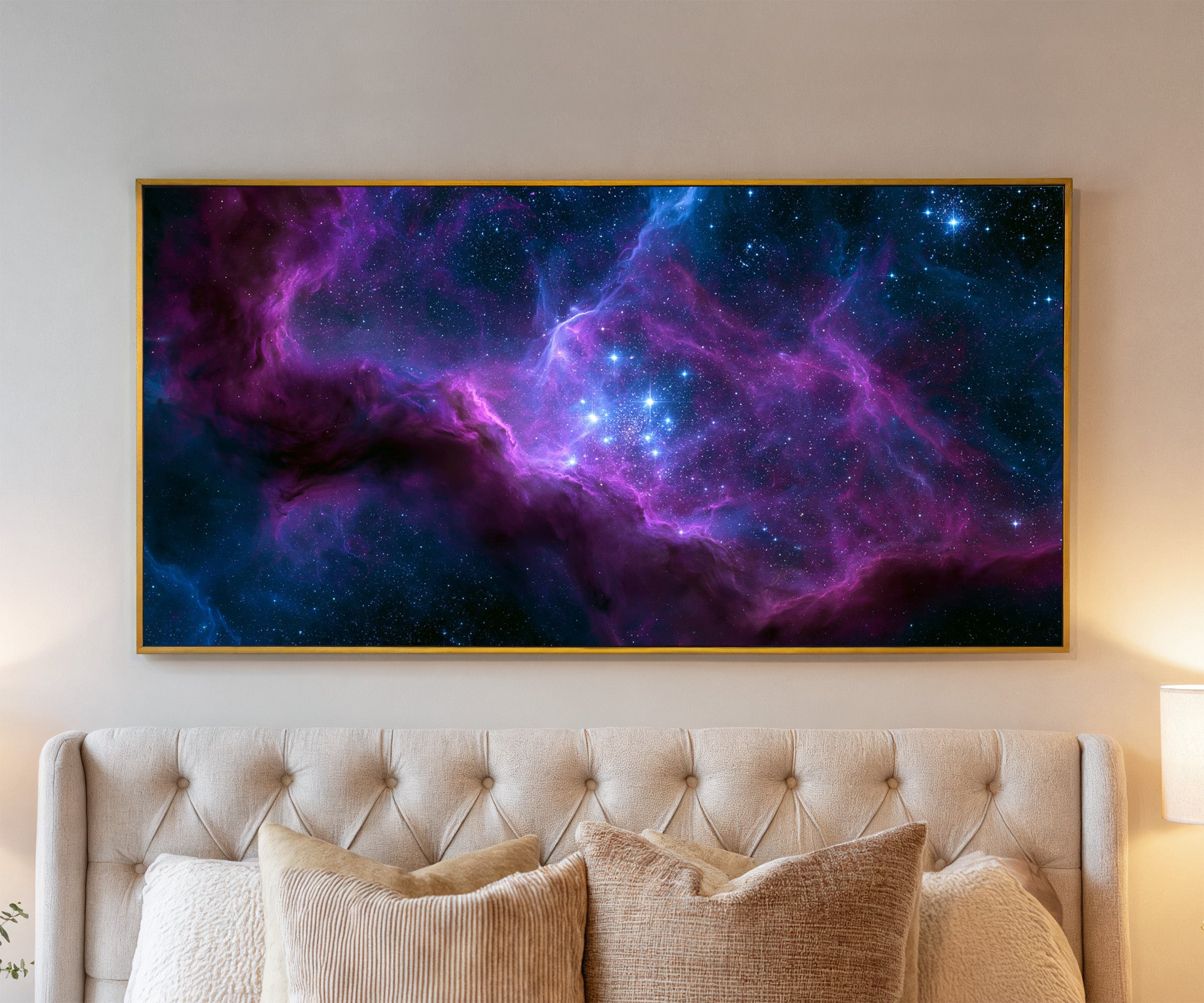 violet and blue nebula with bright star cluster canvas wall art in a gold frame above a bed