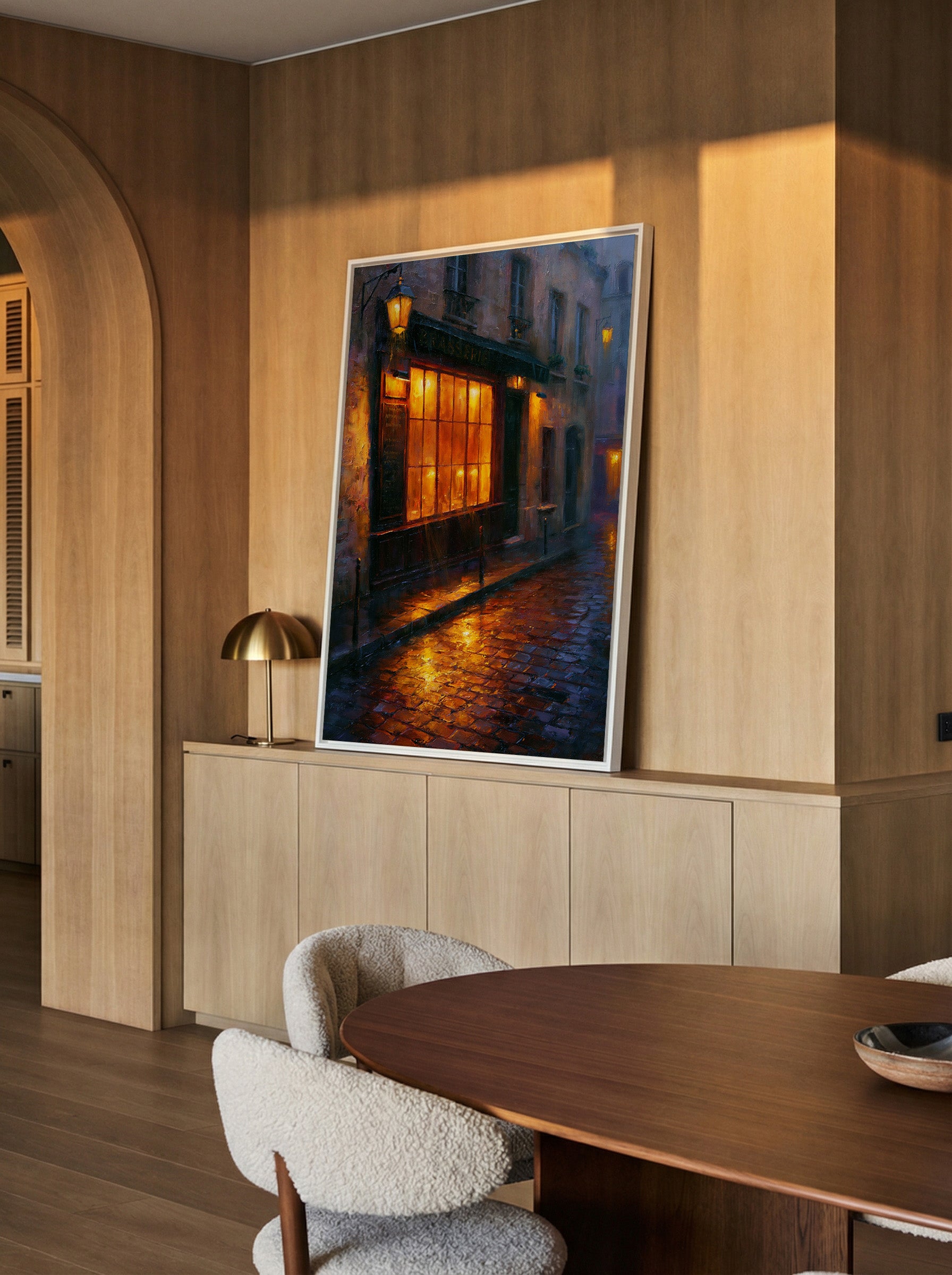 rain soaked parisian street with warm window canvas wall art in a white frame in a styled room setting
