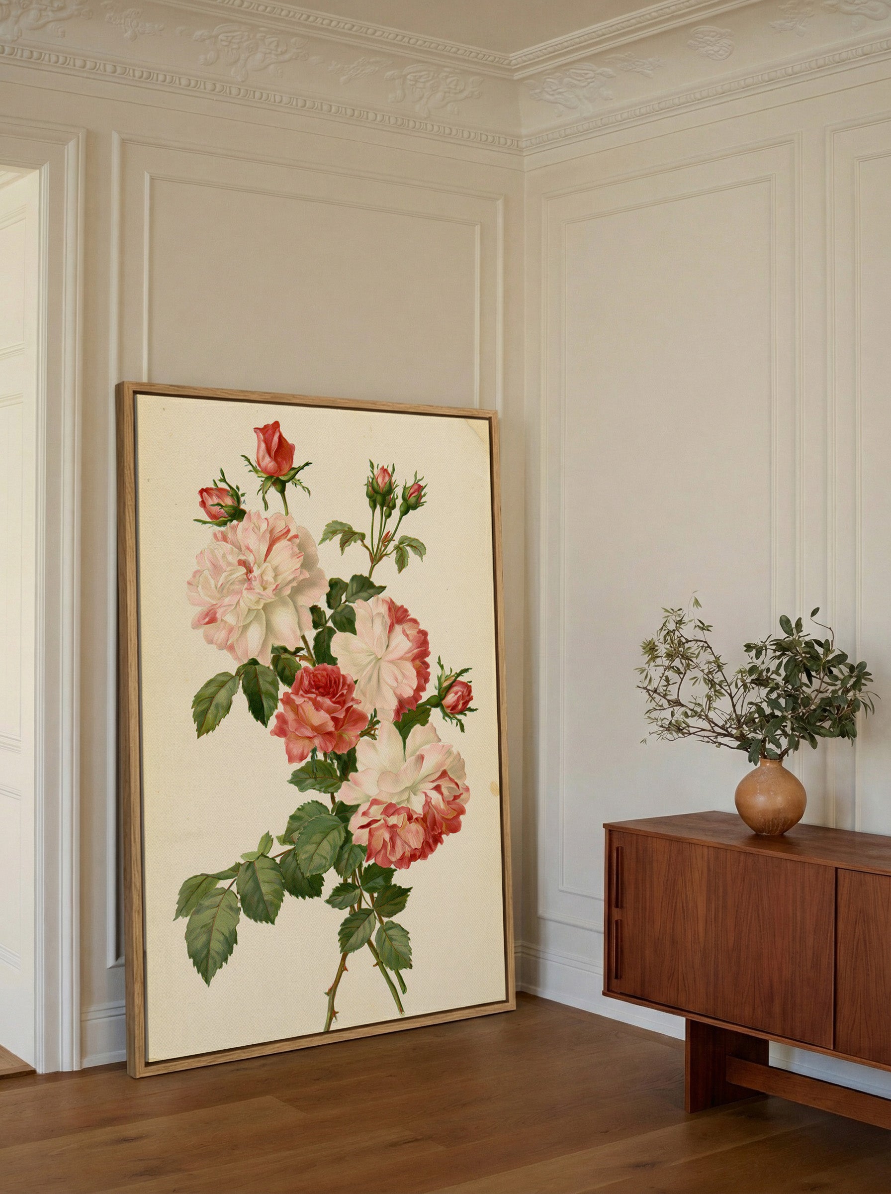 cream and pink rose botanical canvas wall art in an oak frame in a styled room setting