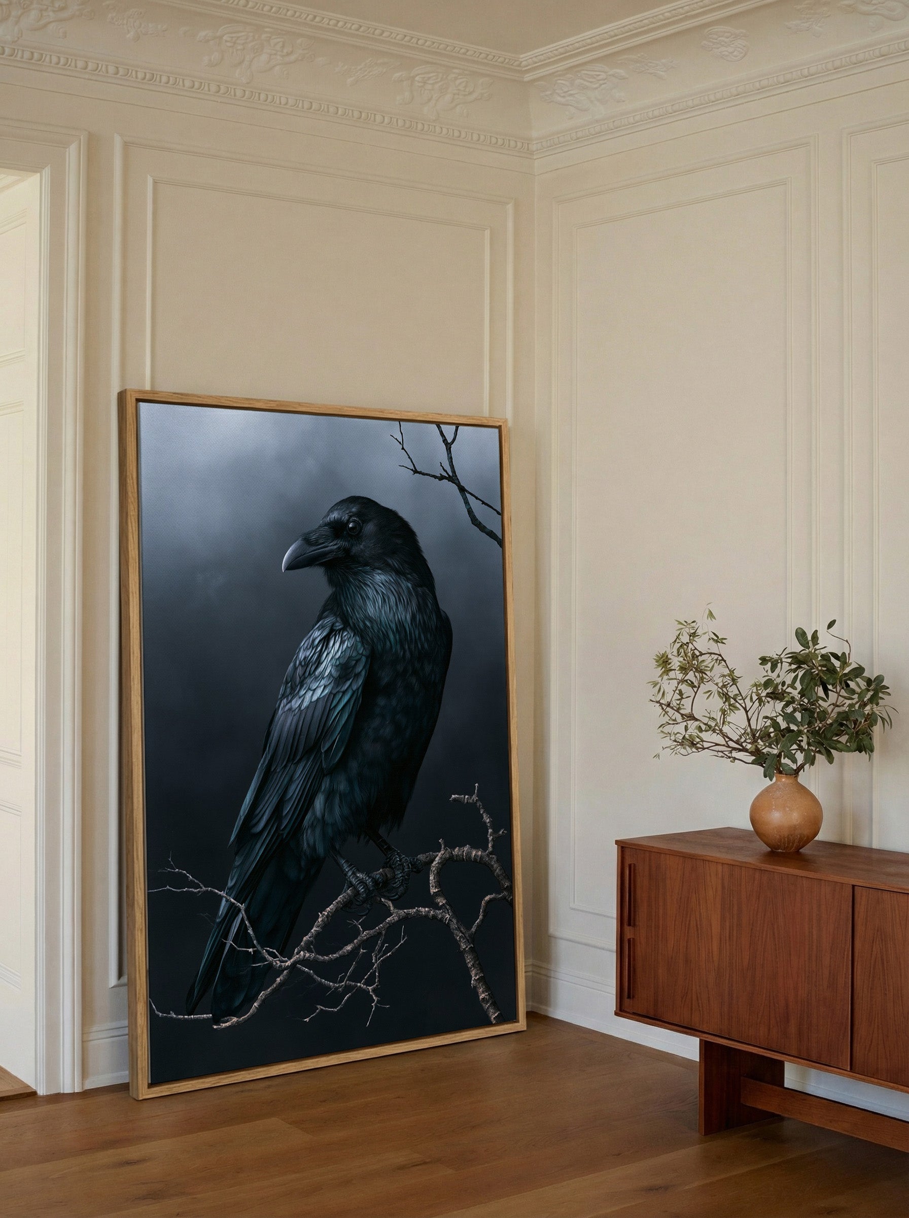 dark raven on bare winter branch canvas wall art in an oak frame in a styled room setting