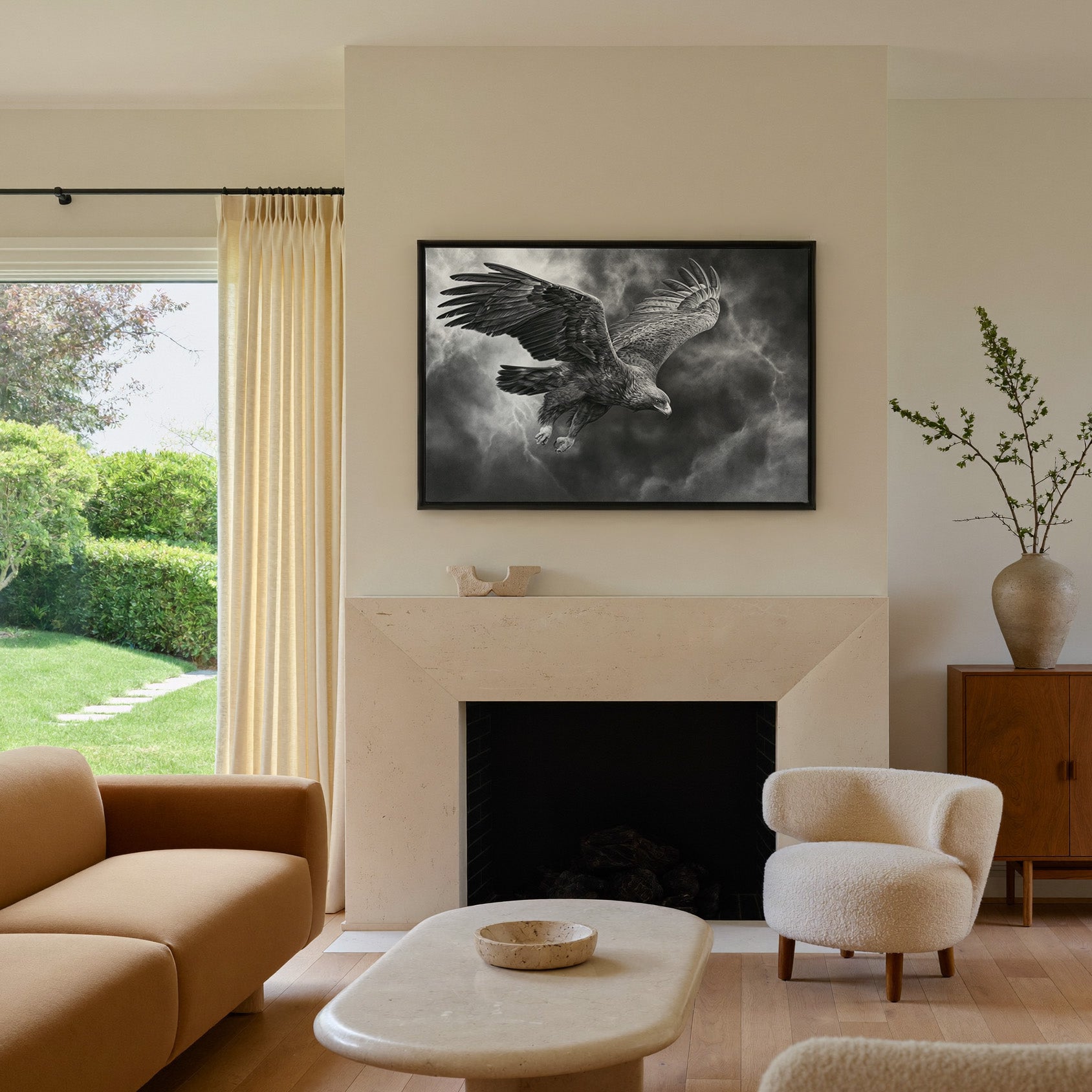 golden eagle in a steep dive through storm canvas wall art in a black frame above a mantel
