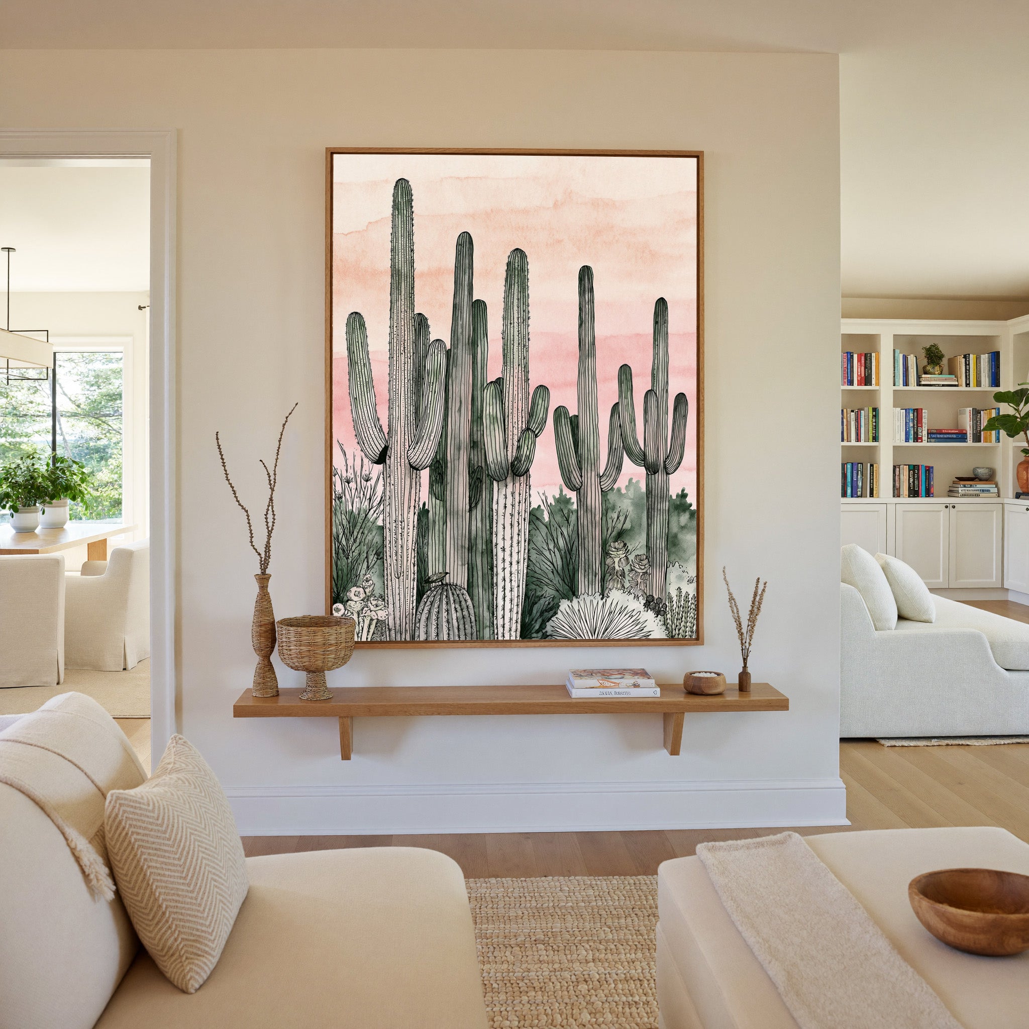 pink dusk sky with tall saguaro columns canvas wall art in an oak frame in a living room